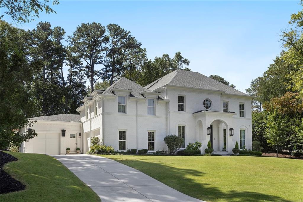 Stunning Custom New Construction in the Heart of Sandy Springs! Welcome to this exceptional 6 bedroom, 6.5 bathroom home designed by Linda MacArthur and built in 2022 by EverCraft Custom Builders. Located in the coveted Heards Ferry Elementary district and just minutes from Atlanta Country Club, Holy Innocents, Mount Vernon, Temple Sinai, and more, this residence offers unmatched convenience and elegance.
From the all-brick exterior with wrought iron doors and gas lanterns to the mature landscaping, the curb appeal is second to none. Inside, soaring ceilings, an open floor plan, and wide-plank white oak floors set the tone for the home’s timeless yet modern design.
The main level showcases a chef’s kitchen with custom cabinetry by Bell Kitchen & Designs, Sub-Zero and Wolf appliances, and a seamless flow into the living area and covered porch. The oversized owner’s suite is a true retreat, featuring a spa-inspired bath with soaking tub, frameless shower, expansive double vanities, and dual custom walk-in closets. Two half baths, a mudroom, and a laundry area complete the main level.
Upstairs, four spacious bedrooms and three full bathrooms are complemented by a dedicated home office and flex space. One of the bedrooms is oversized and offers versatility as a playroom, gym, or additional office, and the second laundry room provides everyday convenience.
The outdoor living space is second to none. A 15-foot accordion glass door opens to a covered screened-in porch with Ipe flooring and a 42-inch gas fireplace. Beyond the porch lies a resort-like setting, with a saltwater heated pebble tech pool edged with Hartstone coping, a fully turfed surround, gazebo, custom grilling station, landscape lighting and even a putting green.
The fully finished terrace level extends the home’s entertainment and lifestyle options, featuring a large entertaining area, full kitchen, home gym with infrared sauna and cold plunge, Trackman Golf Simulator, rec room, and an in-law suite (full bathroom, bedroom and entryway) with private entry. An attached three-car garage rounds out this extraordinary home, which is truly move-in ready with every luxury detail thoughtfully designed.