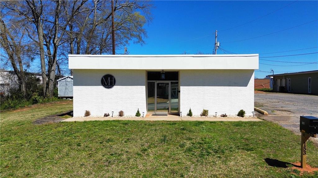 Right in Downtown Commerce, this flexible 2,300 SF space was recently renovated: new epoxy floors, fresh interior/exterior paint, updated lighting/fixtures, refreshed electrical, new drop-ceiling tiles, an updated bathroom, and a added kitchenette. Layout includes three private rooms/offices with the balance wide open-easy to tailor for showroom, bullpen, or client-facing space. Optional on-site shed available for additional storage. Walkable to downtown businesses and amenities; 2 miles to US-441 and 3 miles to I-85-perfectly positioned between both for quick access. Ideal for professional services, boutique retail, studio, or a small team office.