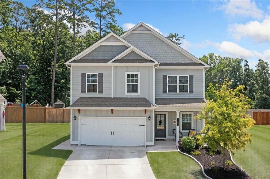 Welcome to this stunning 4-bedroom, 3-bath home that perfectly blends modern design with everyday comfort. Immaculately maintained and thoughtfully designed, this home boasts an open-concept floorplan with soaring ceilings and an abundance of natural light throughout. The spacious living area flows effortlessly into a beautifully appointed kitchen—ideal for entertaining. Featuring a large center island, sleek cabinetry, and granite countertops, this kitchen is a dream for any home chef. A convenient bedroom and full bath are located on the main level, perfect for guests or multigenerational living. Upstairs, enjoy a generous loft/den area—ideal for movie nights, gaming, or a cozy second living space. This space could also serve as an additional bedroom. The oversized owner's suite offers a private retreat with a luxurious en-suite bath. Two additional bedrooms, a full bath, and a well-placed laundry room complete the upper floor. Step outside to relax under the covered patio overlooking the private, fenced backyard—perfect for enjoying warm Georgia days. Located just minutes from downtown Ball Ground’s restaurants and shops, and situated in the sought-after Creekview School District, this home combines convenience, comfort, and style in one perfect package.