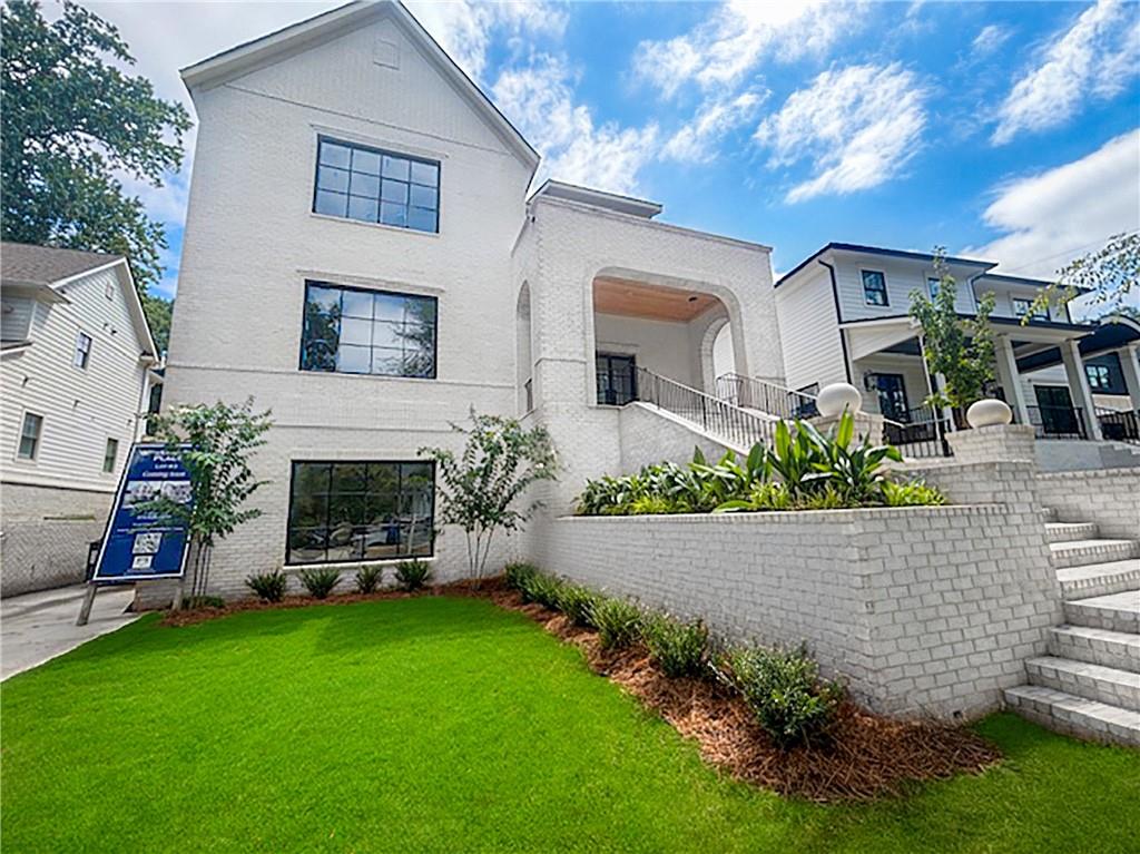 Welcome to your dream home in the heart of Morningside in Midtown Atlanta, where luxury meets comfort! This exquisite 6-bedroom, 5.5-bathroom residence boasts a perfect blend of modern amenities and timeless elegance, making it an entertainer’s paradise. As you enter, you are greeted by a grand 2-story foyer that sets the tone for the entire home. The main level features breathtaking 12' groin-vaulted ceilings and 6” herringbone hardwood floors throughout, creating an inviting atmosphere. The open floor plan seamlessly connects the living, dining, and gourmet kitchen areas, perfect for hosting gatherings with family and friends. Indulge your culinary skills in the state-of-the-art kitchen, equipped with all panel-ready appliances that blend seamlessly into the stained cabinetry. The luxurious details continue with stunning limestone flooring on both the front and rear porches, as well as marble stone shower walls and floors in the spa-like bathrooms. The master suite is a true sanctuary, featuring cedar beams that add warmth and character, along with a beautifully designed in-suite bathroom. Each of the additional bedrooms offers ample space and comfort, ensuring a restful retreat for everyone. Wine enthusiasts will be blown away by the finished basement, which includes a remarkable fully brick 1,000-bottle wine cellar accented by antique 100 year old chandeliers - perfect for curating your collection. For your furry friends, the dedicated dog spa ensures they are pampered as well! Step outside to your own private oasis, complete with an outdoor kitchen surrounded by lush landscaping. This space is ideal for summer barbecues or simply unwinding in the sun. Located within walking distance to a variety of shops and restaurants, this home offers the perfect combination of tranquility and convenience. Don’t miss your chance to own this exceptional property in one of Atlanta’s most sought-after neighborhoods!