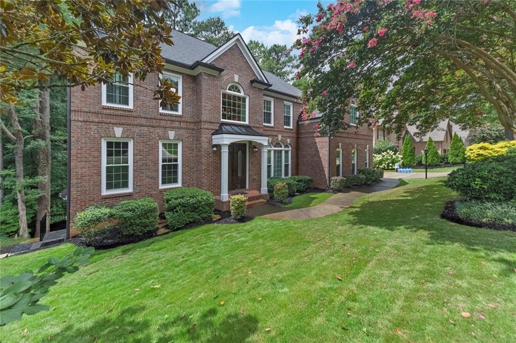 Stunning 5-Bedroom Home in Towne Lake Hills North – Swim/Tennis/Golf Community. Welcome to this elegant 5-bedroom, 5-bath home boasting 4,783 sq ft of beautifully designed living space in the highly sought-after Towne Lake Hills North community. Perfectly positioned in a neighborhood offering resort-style amenities—including swimming, tennis, and golf—this home blends everyday comfort with timeless style. Step inside to find a spacious primary suite featuring two walk-in closets and a spa-like bath. A guest bedroom with full bath on the main level provides convenience and privacy for visitors. The heart of the home is the keeping room with cozy fireplace, seamlessly connected to the kitchen with white cabinetry, stone countertops, and ample workspace. The finished basement is an entertainer’s dream, complete with a stone fireplace, full bar, and theater room—perfect for movie nights or hosting gatherings. Outdoor living shines with double decks and a covered screened area, ideal for year-round relaxation. Recent upgrades including new windows, HVAC, and roof add peace of mind and energy efficiency, making this home truly move-in ready. Call to learn more about possible 3% VA assumable mortgage.