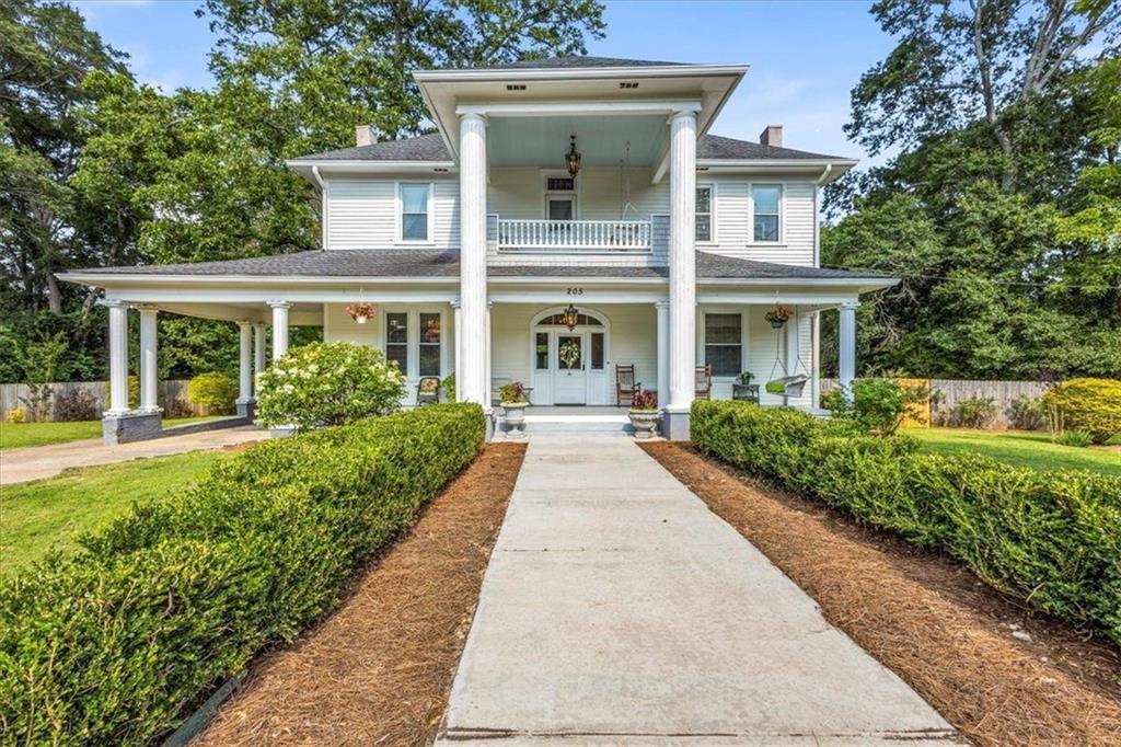 Welcome to 205 Cobb Street, located on 3.07 Acres, this beautiful historical home located in quaint downtown Palmetto is convenient to everything including 20 minutes to Hartsfield Jackson Airport as well as Movie Studios & Mid Town a & much more! You will fall in love with the extensive updating and remodeling that was undertaken in 2013 including all new plumbing/ electrical/ roof/ heat and air/ energy efficient windows, yet the charm and elegance has been maintained* This very large tract of land offers an inground pool for relaxing, and additional property for more projects or possible subdividing* The inviting Double Front Porch whisks you away, and once you step inside, you feel right at home* The Formal Living Room to the left is where you will gather with family and friends, and the Parlor to your right (currently being used as a Home Office) is designed for todays living style* The Formal Dining is perfect for holidays* However, the updated Kitchen is where the magic happens- from the oversized Island/ beautiful cabinetry/ built in pantry/ stainless steel appliances is all the a gourmet chef would want to have* There is a Laundry Center on the main level and a Full Bath with a claw footed tub too* The rear deck overlooks the pool area - but wait, let's go take a look upstairs, up there is where the 3 large Bedrooms are located* Plus another Full Bath and the upstairs front porch* Strolling around the grounds amidst the pecan trees and future garden area is a relaxing way to spend the day* The portico parking area plus additional level drive parking allows for plenty of guests* This is located on a corner lot so there are many options as to what you can do to even further make this property and space what you want it to be* Come fall in love and see this property right away...