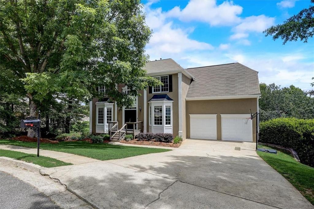 Great value for popular Sugar Hill/Suwanee, including a finished terrace level and a lot with loads of privacy. Hardwood style flooring flows throughout the main level and into the open Florida room situated off the family room! The kitchen boasts white cabinets and a generous island. This home is in great condition.