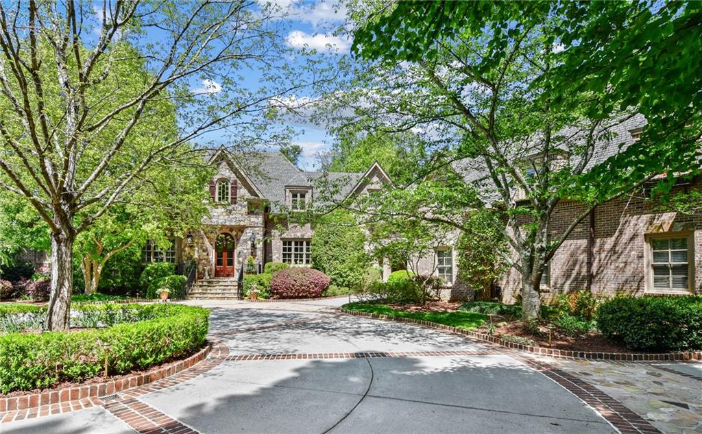 Incredible Harrison Design located in Sandy Springs. This European Oasis is completely gated 1.4+ acres and truly magnificent. Meticulously landscaped. The rooms are spacious and flow efforlessly throughout the house. Fully equipped open eat-in kitchen with keeping room. Separate dining room and formal living room. Primary suite on main with fireplace and doors leading to the patio, overlooking the pool. There are 4 additional bedrooms, 4 baths, in-law suite above the garage, and upstairs laundry room with double washer/dryer. Upstairs entertaining rooms include; theater and playroom with homework area. Finished basement with kitchen, living room, game/golf room, sauna, hair salon and workout room. This property is the ideal place to spend your time indoors or outdoors entertaining with a guest house included. Luxurious resort style pool with spa and covered pavilion, and 2 outdoor fireplaces. Additional outdoor areas include a putting green, soothing fountain, and playground area. 6 Car Garage.