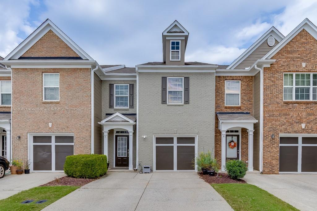 Welcome to this charming 3-bedroom, 2.5-bath townhome featuring an attached 1-car garage, located in the desirable Sherwood Terrace community; renowned for its resort-style amenities and unbeatable convenience. Step inside to a welcoming foyer that opens to a spacious living room with a cozy fireplace, perfect for relaxing evenings. The open-concept kitchen boasts white cabinetry, granite countertops, stainless steel appliances, a spacious pantry, and a generous dining area ideal for entertaining. Luxury flooring flows throughout the main areas, which also includes a guest powder room. Upstairs, the oversized owner’s suite offers vaulted ceilings, a sitting area, a spa-like bath with a separate tub and shower, dual vanities, and a huge walk-in closet. Two additional bedrooms, a full bath, and a large laundry room with extra storage complete the upper level. Enjoy your private fenced backyard, perfect for kids or pets. Recent updates include a new roof and fresh exterior paint, both handled by the HOA-offering peace of mind and low-maintenance living. Community amenities include a swimming pool, tennis courts, pickleball, basketball court, playground, clubhouse, fitness center, and pet park. Located just minutes from Hwy 400, Hwy 141, Buford Dr, Northside Hospital, top-rated schools, parks, and The Marketplace with Costco, Best Buy, TJ Maxx, and more. This move-in-ready home combines style, comfort, and convenience in one amazing package. Don’t miss it!