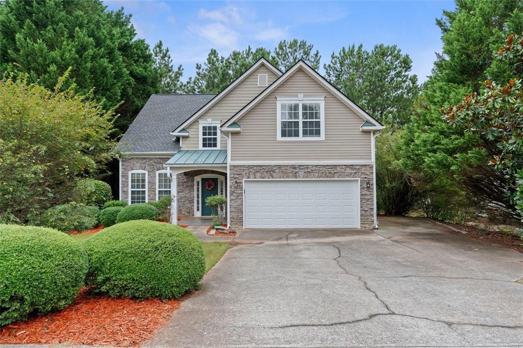 Nestled in a welcoming Gwinnett County swim and tennis community, this 4-bedroom, 2.5 bath home offers a thoughtfully laid-out living space. The home has been lovingly maintained with recent updates including a newer roof and newer HVAC units, giving you peace of mind and comfort from the start. Step into a spacious living room with vaulted, high ceilings. Hardwood floors stretch throughout the main level, except for the primary suite, which features brand-new carpet and a tile-floored ensuite bathroom with a separate shower and soaking tub. The open-concept kitchen flows seamlessly into the living area, making it easy to host friends, keep an eye on what’s happening downstairs, or enjoy a cozy evening in. Upstairs, you’ll find three additional bedrooms all with brand new carpet as well- perfect for guests, a home office, or a growing household. Neutral paint tones throughout create a light, airy feel. A private backyard and deck offer the perfect space to grill out and unwind. And the extended driveway give you plenty of parking options. Living here means more than just loving your home- it’s about enjoying the lifestyle that comes with it. Dacula offers that rare balance of peace and convenience. You’re just minutes from Publix, multiple dining options, and commuter routes, but also close to local favorites like Rabbit Hill Park, where trails and sports fields give everyone a reason to get outside. There’s a strong sense of community here, great schools, and the kind of small-town charm that makes everyday life feel a little more connected.
