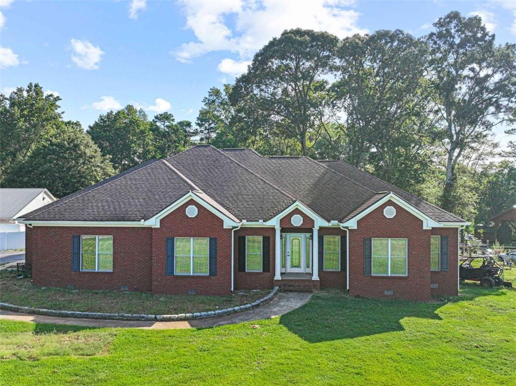 **Charming 3-Bedroom, 2-Bath Brick Home on 3.27 Acres** **2,326 Sq. Ft. 2 Barns RV Hookup Wheelchair Accessible** Experience peaceful country living with modern updates in this beautifully maintained 3-bedroom, 2-bathroom brick home situated on a spacious 3.27-acre lot. With 2,326 square feet of living space, this home combines comfort, convenience, and style, all while being fully wheelchair accessible. Inside, the open layout features a newly updated kitchen equipped with granite countertops, stainless steel appliances, and a wine cooler (Stays with the property). The master suite serves as a private retreat, complete with a walk-in closet, a soaking tub, a separate shower, and a double vanity. For added comfort, new ceiling fans with remote controls have been installed in both the living room and the master bedroom. Additional highlights include: - A new HVAC system (installed in 2023) - A new back deck ideal for outdoor entertaining - A fenced-in backyard, perfect for children or pets - Two barns offering ample storage and workspace - An RV hookup for convenience and travel flexibility Whether you're seeking serene living with room to grow or a move-in-ready home with modern finishes, this property meets all your needs.