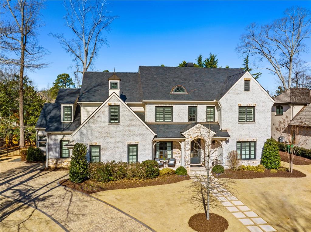 New in Historic Brookhaven, an exceptional opportunity to own a beautiful like-new construction home on a charming enclave of only 8 homes. Impeccably designed by Classic Concepts of Atlanta and built by Deane Johnson Homes, this home is a masterpiece of luxury and craftsmanship. The upgraded natural slate roof and beautiful copper natural gas lantern, as well as professional landscaping, exude curb appeal. The main level has 11’ and 14’ ceilings, stained 8” white oak hardwood floors, 8’ 6-panel hardwood doors, Emtek Rectangular Bronze, and Hampton Crystal Knobs. 3-story elevator ready. The chef’s dream kitchen is elegantly appointed with a 10-foot Island and backsplash made of polished porcelain (Antolli Tech (Italy) Calacatta Lincoln porcelain) with surrounding quartz countertops. Top-of-the-line appliances include a Wolf 30” professional M series double oven, Wolf 48” pro range top with four gas burners and double griddle, Subzero 48” refrigerator/freezer with interior filtered water and ice dispenser, Bosch dishwasher, Scotsman icemaker, Kohler 35” stainless steel under-mount sink, Brizo faucet, Everpure under sink water purifier filtration system. The attached butler’s pantry includes an Electrolux 32” refrigerator, a built-in Frigidaire 27” microwave, and a huge walk-in pantry with custom-designed shelving by Creative Closets. The wet bar includes a hammered nickel bar sink, a Brizo faucet, a wine refrigerator, and a beverage center. Open to the great room (14’ ceilings), enjoy grey wash pine beams, Francois & Co. custom mantle 80” by 60” of French stone grey finish, natural gas fireplace, and Custom designed cabinets flanking the fireplace. The enormous screened porch is a true extension of the living area and can be used all year. You will love the vaulted ceiling and stone fireplace (wood burning) with reclaimed wood mantle. Exit to the ultimate entertainer’s backyard, with a covered porch and a Lynx Sedona 36” grill. The oasis continues to the large Neptune designed saltwater pool, heated hot tub, three sheer descents and lighting, Aqualink iPhone app and remote, and self-cleaning system. The oversized primary retreat includes a 14’ trey ceiling with white washed shiplap and a large walk-in closet with a custom cabinet system by Creative Closets. The spa-like bath welcomes you to relax with counter to ceiling mirrors, Rohl faucets and shower system, large soaking tub, and pristine marble countertops and flooring. Finishing off the main level is an executive study with built-in bookcases, two half baths (one with in and out access to the pool), and a gorgeous laundry room with a dog spa and shower. The second floor (10’ ceilings) consists of 4 spacious en-suite bedrooms, custom vanities by CDK cabinets with quartz countertops, Delta fixtures, and large walk in closets. Also find a laundry room option finished storage space. The terrace level has 10’ ceilings, engineered hardwood floors, an exercise room, full kitchen with Granite kitchen island, Blanco under-mount sink, Samsung refrigerator/freezer (25 cubic ft), and full-size Whirlpool dishwasher. Additional Exceptional features not to miss include: Smart Home Harmonic Homes System (Speakers inside and out) with a remote control app, Ring doorbell, two security cameras, Smart home lighting: Insteon one-touch lighting zones, and three motion detection security lights.