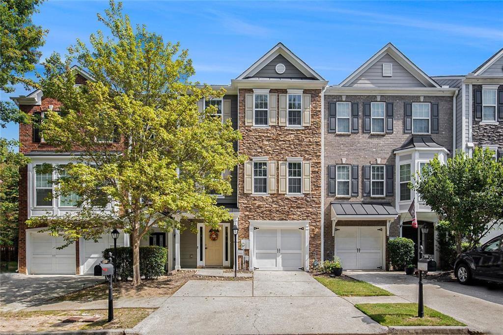 Beautifully maintained 3-bedroom, 3.5-bath townhouse in the desirable Suwanee Station community. This updated home features hardwood floors throughout the main living areas, a modern open-concept kitchen with quartz countertops and stainless steel appliances, and a cozy living room with a gas-log fireplace. Upstairs includes two spacious bedrooms with en-suite baths and walk-in closets. The lower-level bedroom offers flexible use—perfect as a home office, guest suite, or bonus room. Enjoy a private deck for outdoor living, a one-car garage, and an additional parking deck for extra convenience. Community amenities include a clubhouse, pool, tennis courts, and sidewalks. Ideally located with quick access to I-85, and just minutes from Suwanee Town Center, Sims Lake Park, Suwanee Greenway, shopping, dining, and top-rated schools.