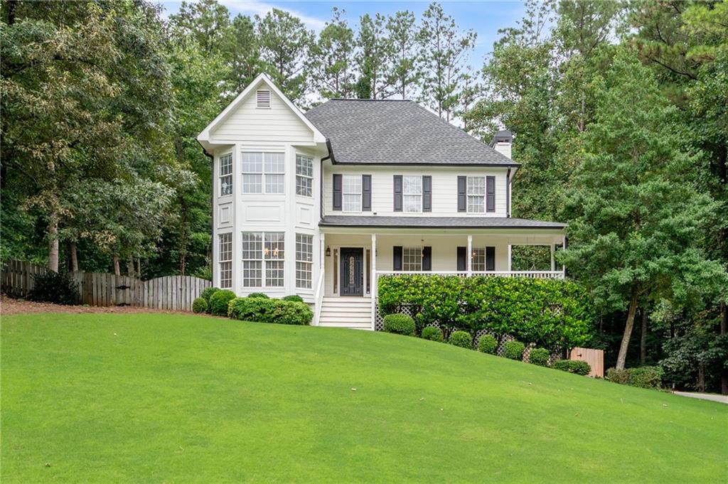 Welcome to 435 Cambrley Lane—a beautifully updated home combining charm, space, and high-end finishes throughout. Enjoy the inviting rocking chair front porch with new lighting and a classic porch swing. Inside, you’ll find ALL NEW flooring: hardwoods on the main level and plush carpet in the bedrooms. The main level features a fully renovated kitchen with new cabinetry, appliances, farmhouse sink, lighting, plumbing fixtures, and modern hardware. Adjacent is a bright family room with a stunning stone fireplace and gas logs, plus a spacious dining room with crown molding that seats 12+. The owner’s suite has been completely updated, boasting a spa-style bath with double vanity, soaking tub with floor-mounted faucet, walk-in shower, and a walk-in closet with built-in vanity. The secondary bedrooms share a beautifully renovated bath with new flooring, vanity, and fixtures. Downstairs, basement includes a large rec room with a bar and built-in shelving—ideal for entertaining or relaxing. Situated on an almost 3/4-acre lot with a flat driveway, oversized fenced backyard, custom outbuilding, and a screened-in porch off the kitchen that provides a peaceful outdoor retreat. This home blends modern upgrades with timeless character—don’t miss your chance to see it! From the moment you arrive, this beautifully upgraded home makes a lasting impression. Close to Schools, Shopping and Dining.