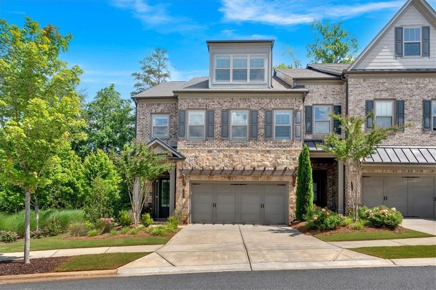 Welcome to this STUNNING three-story luxury end-unit townhome nestled in a highly sought-after gated, resort style community. Just steps from Ameris Bank Amphitheatre and minutes from Avalon, downtown Alpharetta, award winning restaurants and historic Roswell. With top-rated schools, premium amenities, and easy access to GA-400, this home offers the perfect blend of upscale comfort and unmatched convenience. Inside, you'll find designer finishes, an open concept layout, and thoughtful upgrades throughout. Enjoy abundant natural light from additional end-unit windows, and relax in your private, wooded backyard oasis featuring a covered back porch, extended patio with grill pad, lush turf, and the peaceful sound of a water fountain located next to this unit. Inside, the open floor plan connects a gourmet kitchen, spacious family room, and elegant dining area ideal for entertaining. The kitchen features quartz countertops with a waterfall edge, stainless appliances and vent hood, and butler’s pantry. Coffered ceilings in the dining room, designer lighting, and abundant storage closets add both elegance and practicality. This spacious home features 4 bedrooms and 3 1/2 bathrooms, including a gorgeous primary suite with a spa-like en suite bath and custom walk-in closet.  The laundry room located next to primary suite includes custom cabinets, shelves, sink, and granite countertops for both style and function.  The third floor bonus room is a true retreat! Ideal for guests, multigenerational living, or creating a home office, gym or private suite.  It includes a custom built kitchenette with reverse osmosis faucet, designer touches with shiplap walls, custom shelving/window seat and a full bathroom, making the possibilities endless. The home was originally constructed to accommodate an elevator, current owners chose oversized closets on all 3 levels instead, providing abundant storage throughout. An elevator could be installed in the future if desired. Community is quite active with hosting pool parties, music on the green, exercise groups, and more! Amenities include two pools, tennis courts, pickleball, dog park, walking trails and community green space for concerts and special events. Love to garden? This home includes a plot at the community garden through the end of the year - perfect for growing your own veggies, herbs, or flowers. The spot is transferable and can be kept by the new owners if desired. Don't miss this rare opportunity, this home truly has it all... Luxury Living in the Heart of Alpharetta