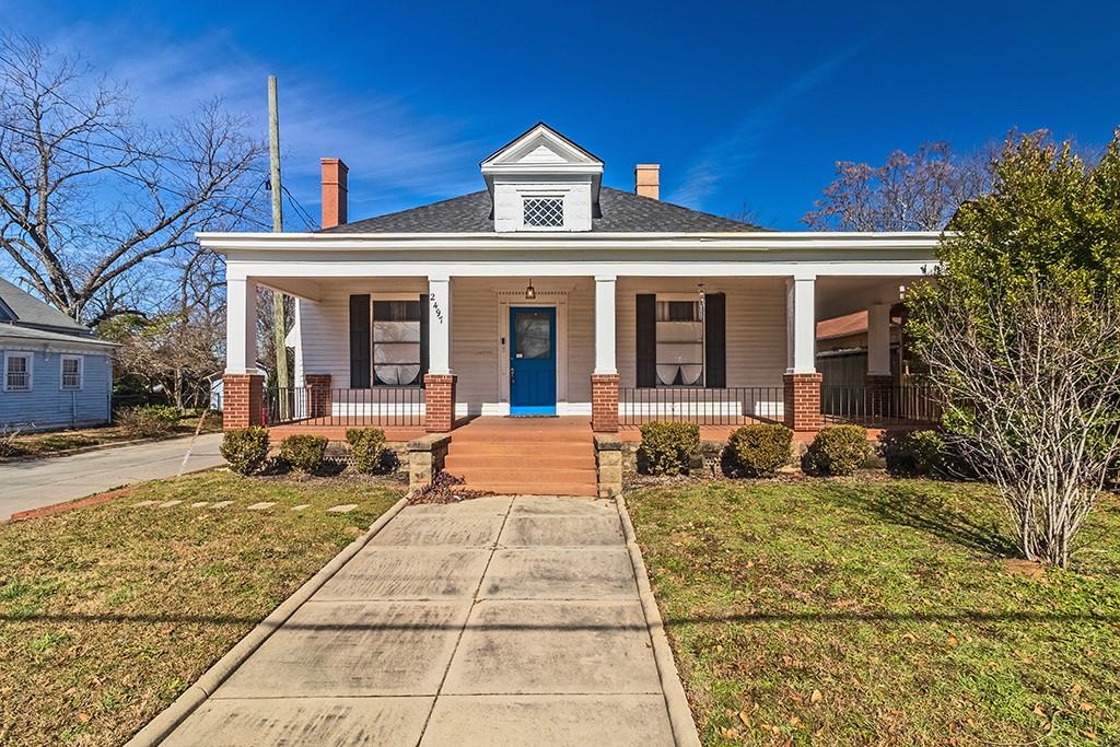 Welcome to Historic Cherokee Heights! Prepare to fall in love with this totally renovated bungalow that perfectly blends timeless charm with modern upgrades. Located less than 2 miles from Mercer University and Mercer University Law School, this rare gem offers an unbeatable combination of location, style, and functionality. As you approach, you'll be captivated by the huge wraparound porch, a serene spot to enjoy your morning coffee or unwind after a long day. Step inside to discover 15-foot ceilings that create an open and airy atmosphere, complemented by the warmth of original hardwood flooring throughout. This 4-bedroom, 2-bath beauty boasts a thoughtfully designed layout, including a spacious living room, a dining area with charming built-in cabinets, and a butler's pantry that adds both character and convenience. A versatile multi-purpose room offers endless possibilities, while the mudroom with washer/dryer connections ensures practicality for everyday living. The fenced backyard is perfect for gatherings, barbecues, or simply enjoying some outdoor tranquility. Whether you're a buyer seeking the vibrant lifestyle of West Downtown or an investor eyeing a fantastic rental opportunity, this home checks all the boxes. Don't miss your chance to own a piece of history with modern flair. Schedule your tour today and experience the charm of Cherokee Heights for yourself!