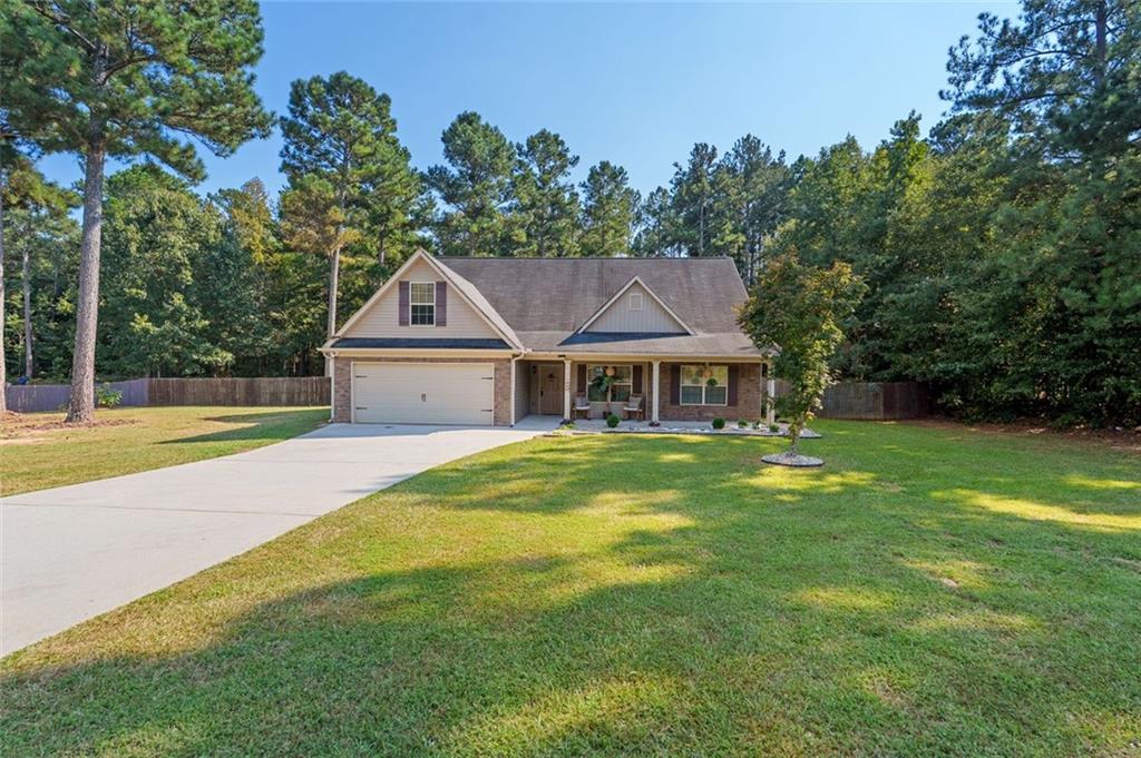 Beautifully maintained home offering luxury-level amenities with no HOA on a private 1-acre lot in McDonough. The spacious living room boasts soaring ceilings, while the kitchen blends style and function with quartz countertops and stainless steel appliances. The owner’s suite includes tray ceilings, a large walk-in closet, and a spa-like bath with a separate tub and shower.
The backyard is an entertainer’s dream with a HUGE covered patio featuring wood-paneled ceilings and custom brick columns, along with a full outdoor bar and dedicated cooking/grilling area. The fenced yard offers plenty of space for gatherings, with additional room in the back for chickens.
Other highlights include fresh interior paint, appliances included, great curb appeal, newly installed HVAC systems (April 2025), and a recently serviced septic tank (February 2024). This property combines comfort, entertainment, and privacy—all move-in ready.