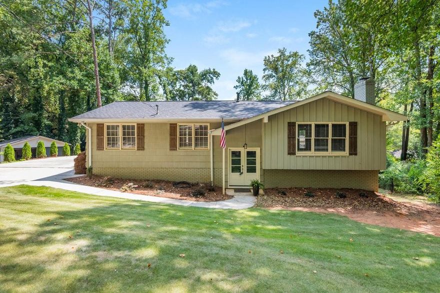Located in the vibrant heart of Marietta, GA., just three minutes from the charming Marietta Square, 295 Redwood boasts a series of thoughtful upgrades throughout. New hardwood floors extend throughout the main level of the home, bringing warmth and character into each room. The newly renovated open-concept chef’s kitchen stands out as a culinary masterpiece, featuring white quartz countertops, custom cabinetry with pull out shelving, Z-line commercial grade gas range and oversized island ideal for both entertaining and family gatherings. An exposed ceiling beam offers separation between the eat-in kitchen and open living room space that features a wood burning brick fireplace surround. This home offers four generously sized bedrooms and three remodeled, full bathrooms, including a newly added full bathroom on the terrace level.  A large, newly painted deck spans the length of the home and overlooks the half-acre flat backyard that offers countless opportunities for landscaping, gardening, or the addition of extra structures such as a pool. With footings poured, the new driveway offers the opportunity to install a double garage with the option of adding additional living space above the garage. With its prime location, high end upgrades, and expansive outdoor living space, this home is truly a standout property. Schedule a showing today and experience the unparalleled charm of 295 Redwood Dr.