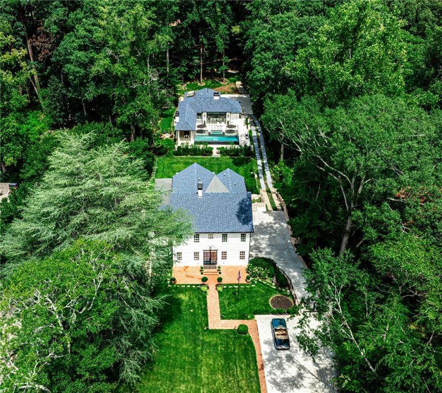 If you’re looking for something that has all the bells and whistles…THIS IS IT! The sellers have renovated every inch to the studs, yet have kept the integrity of the home’s 1920’s charm. With the expertise of architect, Cody Patton and interior designer, Hope Austin, this home underwent a transformative expansion completed in May 2022, adding 2,500 square feet of living space and a stunning pool house. There is a main floor, a second story with 5 bedrooms, 4 bathrooms, a laundry room and a bunk room and a basement with another laundry room with a dog wash, an au pair suite, wine cellar and a game room with a separate entrance. 

The heart of the home boasts a harmonious blend of old and new illuminated by Circa lighting fixtures throughout. Steel doors and windows enhance the flow of natural light, adding a modern touch to the space. There are two offices on the main level, one is adorned with Clarke & Clarke wallpaper, while a discreet hidden door leads to a private office tucked away behind a bookcase off of the formal living room. 

A sophisticated color palette of navy, citrine, and peridot. The kitchen and butler's pantry are a chef's dream, featuring soft gray cabinetry, top-of-the-line Miele and Sub-Zero appliances, and a Wolf oven/range. Adjacent to the kitchen is a fabulous banquette that opens up to the family room and leads to the back deck that overlooks the backyard and pool house. 

Outdoor living is elevated with a 900 square foot pool, a 24-hole golf chipping course, a basketball court, two fire pits, an outdoor grill. The pool house is an entertainer's paradise featuring a Trackman golf simulator, a greenhouse, an art studio, guest bedroom, kitchen and bar, bunk room, 1.5 baths, laundry room, 2-car garage, and custom designed landscaping.

Additional highlights include a total of three laundry rooms, an beautifully designed and chic wine cellar that is WhisperKOOL-enabled, a three-car garage with Tesla charger, a fully equipped gym, a bonus attic with sleeping accommodations for four, a bocce court, sprawling 5,600 square foot green sports lawn and a generator that services the entire house. The home's modern and historic elements blend seamlessly…this one is nothing short of spectacular.