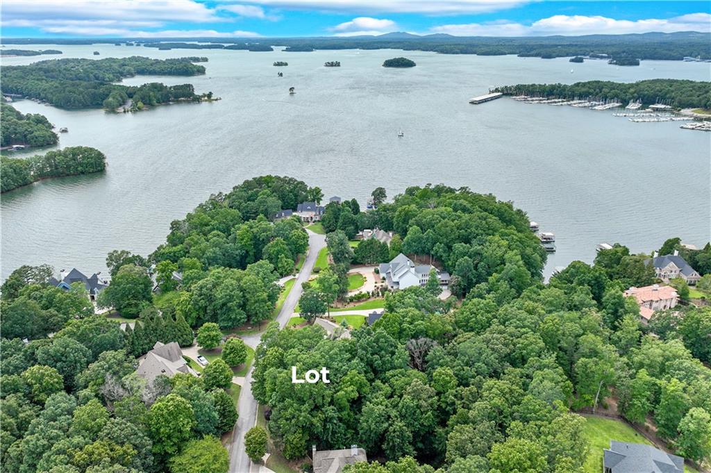 Discover the perfect canvas for your dream home in one of Lake Lanier's most desirable communities-Pointe South - a neighborhood of homes ranging from 1-4 Million. This spectacular .80-acre private lot is one of the last remaining opportunities to build in this prestigious lakeside neighborhood, located on one of the most sought-after streets on the lake. Positioned between 5510 and 5518 Mainsail Way, Lot 18 offers seasonal lake views (possibly more once the lot is cleared for building) a peaceful setting, and a gentle rolling topography-ideal for your custom build of a basement home. The survey and soil tests have already been completed, and a proposed house plan is available to help jump-start your vision. There is not a dock slip nor permit with this property. Imagine waking up to Lake Lanier sunrises and living just minutes from Sunrise Cove Marina, where your boat or watercraft can be ready at a moment's notice. You'll also enjoy convenient access to shopping, dining, and medical care, making this the best of lake living with everyday ease. Secure your spot in one of Lake Lanier's finest communities - Pointe South. Contact us today to walk the lot and explore the possibilities!