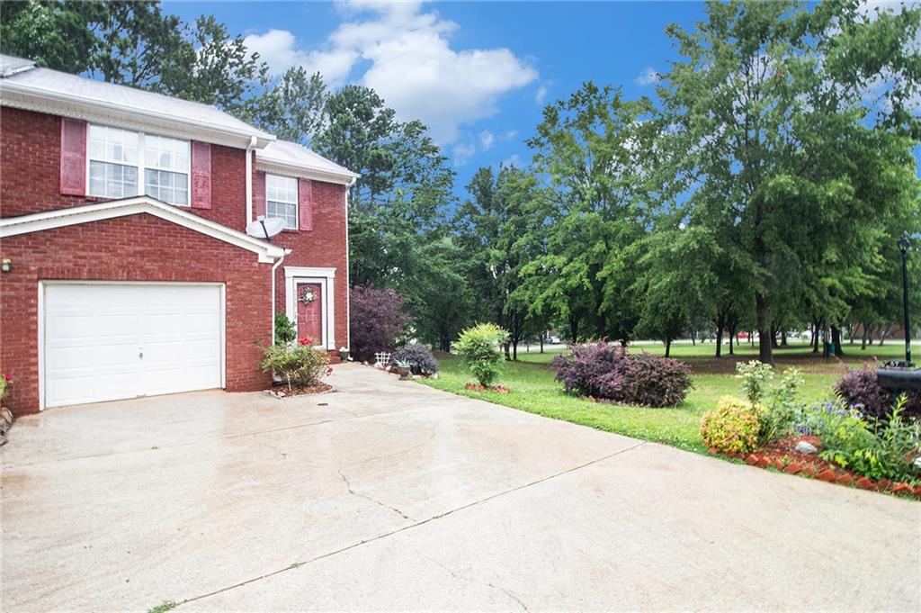 Welcome home to this sweet end unit townhome with a park like .65 acre open green space right outside your door. Enter through the large foyer into a spacious two-story living room with gas log fireplace. The open concept design flows into the dining area and kitchen perfect for relaxing and entertaining family and friends. A conveniently located powder room is just inside the foyer. On the second level you will find a primary suite offering an expansive bedroom and private ensuite bathroom and a second bedroom with an additional full bathroom in the hallway. Enjoy the outdoors in the charming back garden that opens into the adjoining community greenspace. Landscaping features include abundant flowers and mature shrubs and plantings. Recent updates include fresh interior paint, updated/serviced HVAC system, and newly pressure washed exterior, deck, and driveway.
