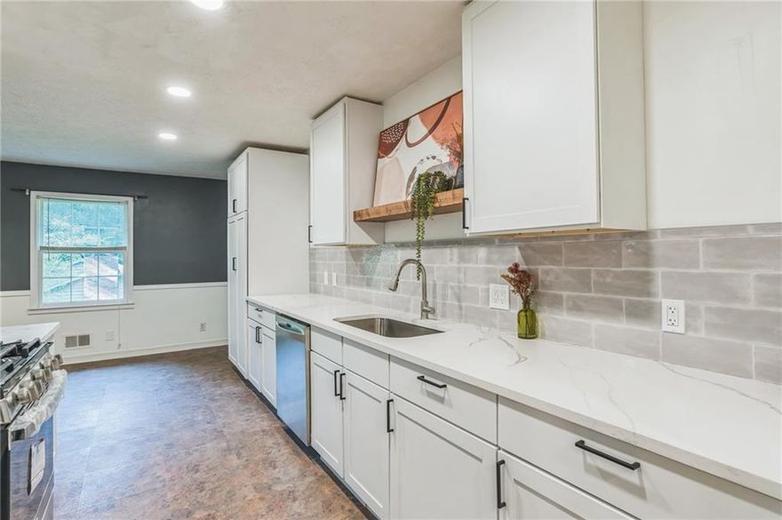 **Seller will install additional upper kitchen cabinets before closing if buyer so desires such cabinetry**  Welcome to this beautifully remodeled 4 bedroom 3 bath ranch on a spacious unfinished basement.  The lower level allows for ample storage and contains room for potential future buildout.  This house sits on a gorgeous tree-lined street in one of Cobb’s top school districts; the Hillgrove/Lovinggood cluster. Step outside to enjoy a generously sized, fully fenced yard with a stone fire pit area—ideal for entertaining, relaxing, or giving pets and kids room to play.  Less than a mile away, enjoy a leisurely stroll to retail shopping, restaurants, Sprouts Farmers Market, Crunch gym and more. This property is ideally situated less than 10 minutes from the beautiful hiking trails of Kennesaw Mountain, and less than 15 minutes to Marietta Square.  The kitchen is a true highlight, featuring beautiful quartz countertops, solid maple cabinets, new stainless steel appliances, soft close drawers and doors, beautiful floating shelves, ample pantry space, stainless steel range hood and more.  The main level showcases modern LVP flooring that adds both style and durability, creating a warm and cohesive feel throughout.  The large, vaulted sun room flooded with light is a true gem and a place for complete serenity as you enjoy views of the spacious yard through the oversized windows.  The property also has a covered front porch and wood deck, perfect for sitting out on warm summer nights.  Major updates include a new waterproofing system with lifetime warranty, HVAC and hot water heater replaced in 2024, giving you peace of mind for years to come. This home combines modern comfort with thoughtful upgrades, making it move-in ready for its next owners. Priced to sell. Recent comps suggest that there is instant equity for the buyer upon closing at this adjusted price. View it before it's gone!