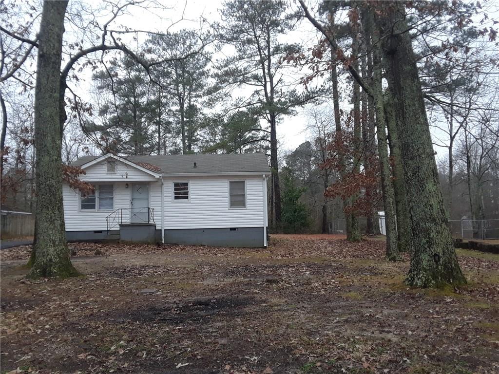 This spacious bungalow has been updated and presents a neutral theme. The new carpet, paint, and flooring in kitchen, provides for an invitingly renewed home. Rooms are surprisingly spacious and the layout has a good flow. The square footage does not include the additional room on the back of the house, bright and sunny with laundry area and sitting area off bedroom. Located near the new school on Factory Shoals, easy access to I-20, dining, entertainment and all conveniences. The large lot is ideal for the gardener or outdoor entertainment.