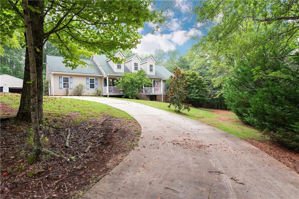 Looking for something off the beaten path, but still close to everywhere you want or need to be? Look no further than 556 Fuller Road! Located in Jackson county with an Athens address, this thoughtfully planned home sits on just under 10 private acres tucked away in the woods, yet oh so close to all the amenities Athens has to offer. Five minutes to the new Oak Grove Publix shopping center; fifteen minutes to downtown Athens or head the other way, and it is a quick drive up to the quaint city of Jefferson and I-85. Step into the large foyer for a welcoming introduction to this home. Just beyond the foyer, soaring ceilings in the great room offer a sense of cozy spaciousness, with views to the outdoors drawing in the calm that nature provides. The kitchen offers plenty of cabinet and countertop space. A sweet breakfast nook accommodates a quick place to enjoy a meal, and there is a separate dining room for family and entertaining as well! A nice-sized pantry adjacent to the laundry room rounds out this area. At the back of the house, you'll find the primary suite which offers french doors to the outdoor living space, along with an en suite bath with dual closets, soaking tub, separate shower, and private toilet room. In the front there are two more good-sized bedrooms that share a hall bath. In between the front and back bedroom spaces is also a wonderful flex room that is currently being used as an office. Upstairs you will find yet another bedroom and full bath, as well as an additional living/hangout space. Spend your days lounging poolside on the expansive covered back porch, or watching the deer graze from the front porch rocking chairs! Plenty of room for a mini-farm, with a small barn, paddock, and small open pasture to the right of the house. A hunting enthusiast will enjoy multiple sites for stands and blinds. Property has been food-plotted in the past, and there are generations of deer that still visit. Wildlife abounds! The home has an attached two car garage that is level with the main floor and an additional, separate two-door garage/shop at the end of the driveway. There is also an unfinished daylight basement with a half bath. The basement has both a roll-up door and a walk through door. So much space for all your storage and/or workshop needs. If you love the outdoors, or just enjoy your privacy, you'll want to call 556 Fuller Road home! Make your appointment to see it today!