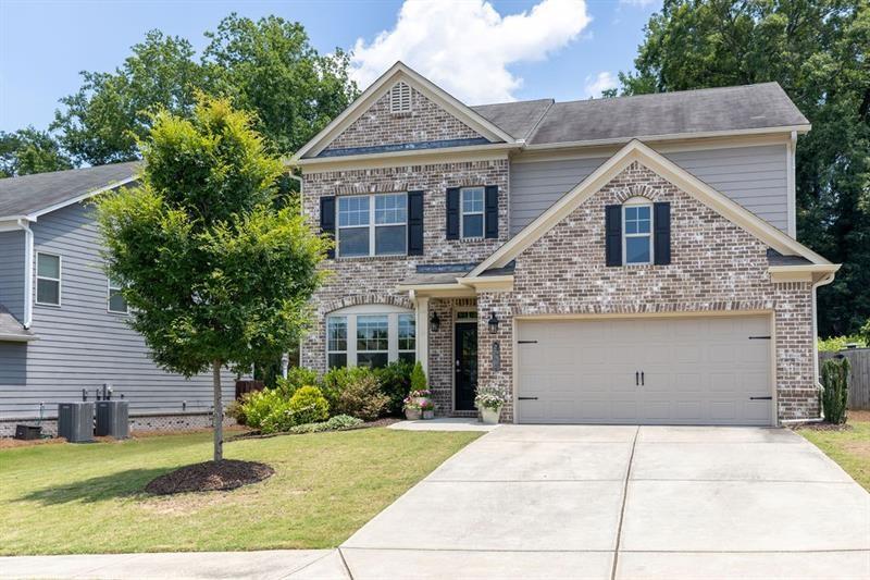 Now's your opportunity to live in a great location. Welcome home to this beautifully appointed 4 bedroom, 2.5 bath house in Lakeview at Ivy Creek. Entering the home you will step into a large foyer with lovely wainscoting, 9' ceilings, and hardwoods throughout first floor. Off the foyer is a flexible room that could be a dining, living, office, or play room. The half bath is a charmer with gold hardware, tall paneling, and tasteful wallpaper. Enjoy open concept living with kitchen, dining area, and family room with fireplace to rear of home. The kitchen has 42" upper cabinets, granite countertops, SS appliances including range, microwave, and dishwasher. There's even a space for a coffee station. Enjoy privacy outside under a covered porch. The large fenced, flat backyard has been professionally landscaped and includes a firepit area. Upstairs a generous landing leads to the primary suite with spa-like bathroom and large walk in closet. Three additional bedrooms along with extra bath with double vanity offer plenty of room for growth. Upstairs is a generous sized laundry room. The Community Pool and mail kiosk are directly across the street. Take a stroll through the neighborhood enjoying wooded areas and even a small pond. So close to Mall of Georgia, Little Mulberry Park, The Exchange, Interstates, and so many other great attractions. You will want to make this house your home!
