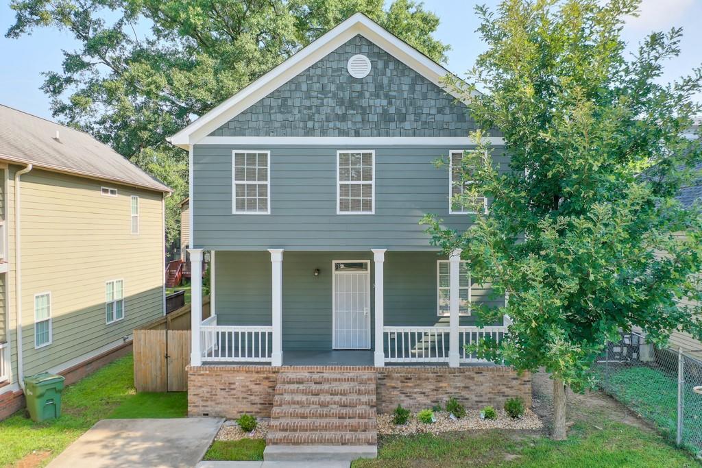 Welcome home to this beautiful, true 5-bedroom home in the heart of the city. This floor plan and offering provides an extraordinary amount of versatility. There is a bedroom, walk-in-closet, and full en-suite bath on the main level. There is an additional powder room on the main level, creating additional value as you host and entertain guests. As you enter through one of two front porches, you'll be impressed by the open floor plan that stretches towards the beautiful kitchen. White cabinets, stainless steel appliances, and granite counters are conveniently located near the back door which opens into a screened-in porch and fully fenced back yard. Enjoy off-street parking in your driveway, freshly painted pewter green exterior, and city views. The upstairs boats 4 bedrooms, one complete with a walk-in closet, supremely convenient access to laundry room, and a beautifully finished, sleek bathroom. This community is extremely popular with both short and long-term rentals. Conveniently located near every major college and university in the Atlanta area, the opportunity for student housing is immense. With proximity to the GWCC, Mercedes-Benz Stadium, and public transportation, this property could be a tremdous asset for AirBnB or other short-term rental options. Last, but certainly not least, owner occupants that desire a move-in ready home with 5/3.5 bed and bath can enjoy the city views, proximity to the BeltLine and easy access to the entirety of the city, MARTA, restaurants and night life, this is the home for you. Enjoy fresh paint inside and out, new water heater, several updated bathrooms, new carpet, and a three-year-old main-level HVAC system. This home has been well-cared for and thoughtfully updated. It is rare to find a true 5 bedroom home in this location and at this price point - come see it today!