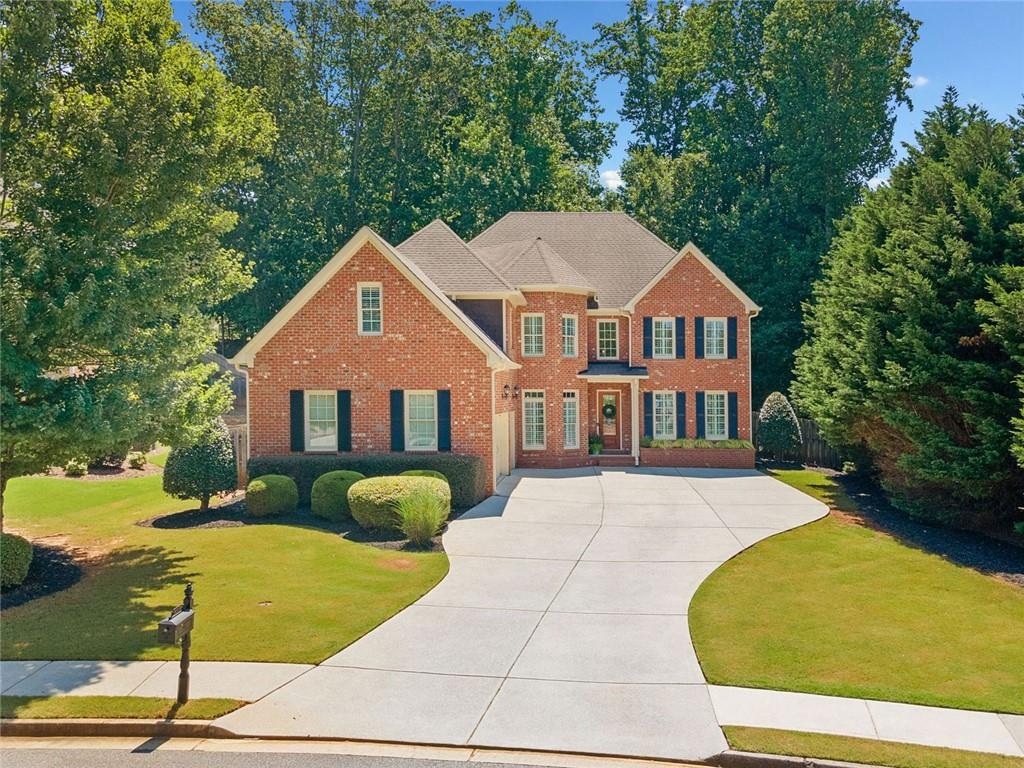 Welcome to 4550 Wigley Estates Road - a stylish executive home in East Cobb! This beautifully updated 3-sided brick residence offers the perfect blend of luxury, functionality, and location. Nestled on a private, flat, fully fenced lot with mature trees, this home features a 3-car garage and a spacious, thoughtfully designed floorplan ideal for modern living. Step inside to discover new LVP flooring throughout the main level, fresh neutral paint, and striking updated lighting fixtures. The home exudes contemporary elegance, with soaring ceilings and stylish finishes throughout. The powder bath has been fully remodeled and features a dramatic black Calacatta Monaco waterfall sink that makes a bold statement. The main level includes a dedicated office and a versatile guest suite with an ensuite bath - currently used as a home gym. Entertain effortlessly with a formal dining room, a spacious family room with an updated fireplace, an additional cozy sitting room, and a second updated fireplace for added charm. Culinary enthusiasts will appreciate the well-appointed kitchen, complete with stainless steel appliances, and ample cabinetry. Upstairs, retreat to the expansive primary suite with a serene sitting area, luxurious bathroom with his-and-hers vanities, a soaking tub, separate shower, and an impressively large walk-in closet. Two secondary bedrooms share a convenient Jack-and-Jill bath, while a third bedroom enjoys its own ensuite. A large bonus room completes the upper level - ideal as a media room or home theater. Located approximately a mile off Sandy Plains Road, this home is minutes from shopping, dining, and entertainment in both Downtown Woodstock and Downtown Roswell. Zoned for top-rated East Cobb schools, this property offers exceptional value and lifestyle in one the area's most sought-after communities. Stylish, spacious, and move-in ready, this one checks all the boxes. Come see it for yourself!