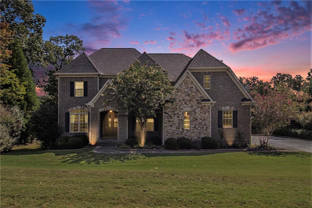 Welcome home! Discover refined Southern living at this stunning custom residence built by Colombo Homes. Tucked away in the serene River Walk community of Douglasville, this 2014 build was thoughtfully designed with comfort, space, and style in mind. This 5-bedroom, 5-bathroom home offers elegant living on nearly an acre of beautifully manicured land. From the moment you arrive, the home's curb appeal is undeniable. A covered front porch welcomes you into a grand two-story foyer, where natural light floods the open layout. Soaring ceilings, timeless trim details, hardwood flooring and designer finishes create a sense of quiet luxury throughout. At the heart of the home is a chef’s kitchen outfitted with custom distressed 42" cabinets, granite countertops, tile backsplash, stainless steel appliances, and a generous center island perfect for gathering. The kitchen flows seamlessly into the breakfast area and the inviting family room with custom built-ins, and offering a fireplace for a cozy retreat. Rounding out the first floor is the formal living/dining rooms, and private office. Upstairs, The private primary suite is a peaceful haven, complete with a tray ceiling, spa-inspired bathroom, and an oversized custom walk-in closet. you'll find three additional bedrooms, two full bathrooms, and a spacious media room that can easily serve as an additional bedroom, home theater, playroom, or office. Step outside to the back patio overlooking a backyard with tranquil views —ideal for morning coffee or evening gatherings. The fully finished basement offers an additional bedroom, full bath, wet bar, and additional flex spaces. The backyard features a rear porch, and plenty of green space for gardening or play. Additional features include a spacious three-car garage, professional landscaping, and ample storage throughout. Located in a quiet, upscale neighborhood with sidewalks and street lights. Schedule your private showing today and see what makes this home truly special. Happy Showing!