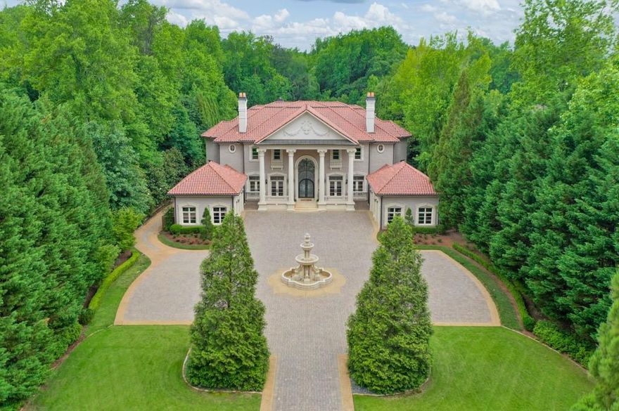 Exquisite gated estate on 2.2 acres in top Walton school district in low tax Cobb County showcasing the finest finishes, stonework, unmatched quality, and artisanship from all around the world. The dramatic hand carved tigers meet you as you drive through the gates surrounded by the lush landscaping and into the full circle motor court bordering a custom hand carved stone swan limestone fountain and garage housing for four vehicles. Dramatic castle-entry front doors welcome you with grandeur. Baccarat and Murano lighting line the interior as you view the stunning baroque double spiral staircase with hand-forged Cantara ironwork, marble floors with imported Rossini mediations, gilded trim and hand laid 24 carat gold leafed domes. Arched cantara doors lead to private entry into the lush Primary suite on main with unbelievable spa bath - marble and hand laid gold mosaic tiles, stunning gold Sherle Wagner fixtures. Three separate kitchens with Viking and subZero appliances can be found throughout the estate. Terrace level features -gym with redwood sauna, Cantara wine cellar, and home theater featuring legendary Klipsch sound system, precise lighting and acoustically rich fabrics providing for unforgettable private screenings. The finest of imported mosaics were meticulously hand-applied by Fantini Mosaici's team of artisans to create the breath taking pool and spa, only otherwise found within the finest Italian luxury villas and resorts. Separate pool house includes a full kitchen and guest suite. Lighted Deco Turf tennis court behind the pool house, the same surface as used in the US Open. Lacey champion hand tufted wool carpets (also seen in the White House) found in various rooms throughout the house. 6 fireplaces, all custom with unique imported finishes from around the world. Additional features include an elevator servicing all three levels and custom closets designed to complement each room's unique style, ensuring both convenience and luxury at every turn.