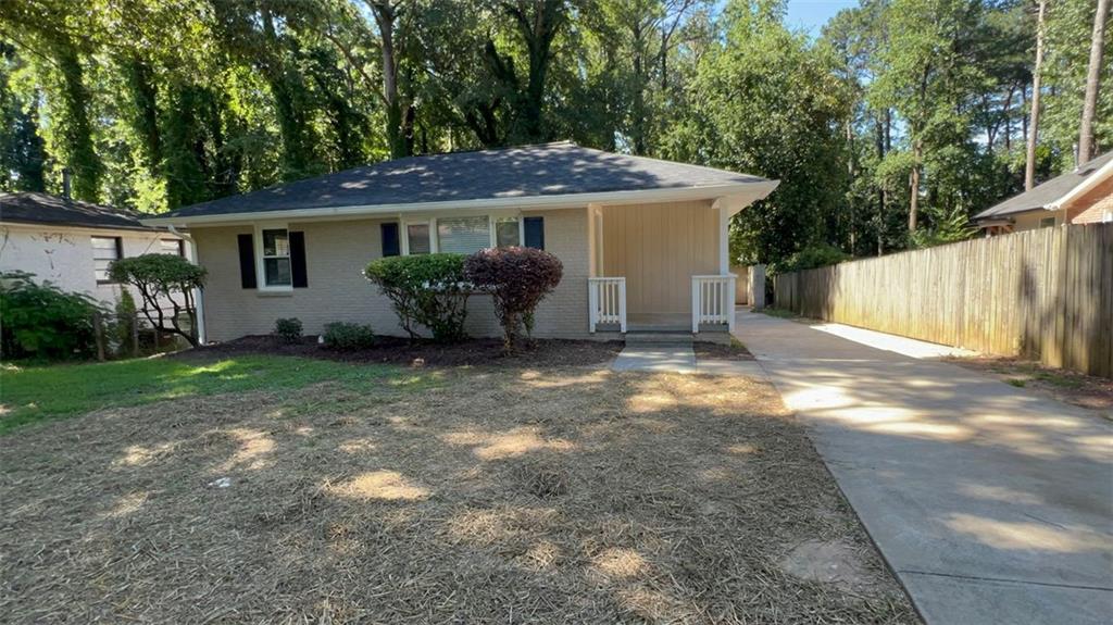 Move-in ready ranch-style home featuring a 4/2 layout, a covered carport, and a decent-sized backyard perfect for outdoor enjoyment. The home offers a functional floor plan ideal for families or those needing extra space. Great option for buyers seeking comfort and convenience in a well-maintained property.