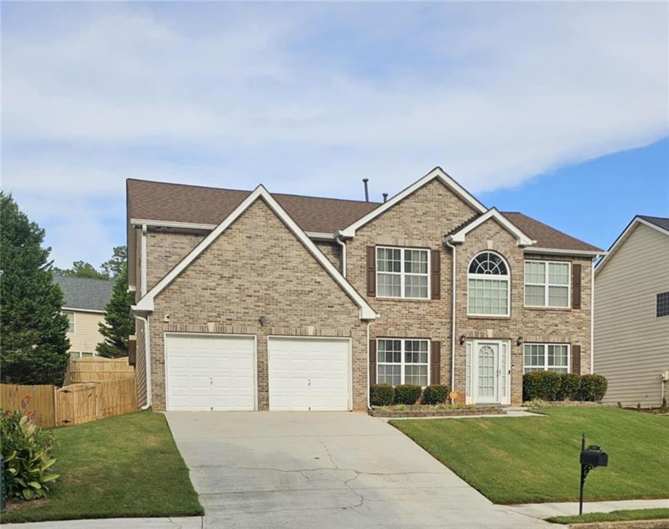 Welcome to this stunning 5-bedroom, 3-bathroom home in the heart of Fairburn - a rare gem offering space, style, and comfort. Thoughtfully designed and impeccably maintained, this home stands out with fresh paint throughout, and zero carpet for easy maintenance and modern appeal. The main level features a spacious bedroom and full bath, perfect for guests or multigenerational living. Upstairs, you'll find four additional bedrooms, including a luxurious master ensuite that truly sets this home apart. The oversized master retreat boasts a private sitting area with a cozy fireplace, a massive walk-in closet, and a spa-like bathroom that offers the perfect escape at the end of the day. Step outside to enjoy peaceful mornings and relaxing evenings on the screened-in back patio, ideal for year-round outdoor living. The home's fresh, neutral color palette and high-quality finishes make it move-in ready and easy to personalize. With its functional layout, multiple living options, and beautifully kept condition, this home offers a unique blend of elegance and practicality - all nestled in a quiet, well-established neighborhood in Fairburn. Don't miss the chance to make this exceptional property your own! This home is agent owned.