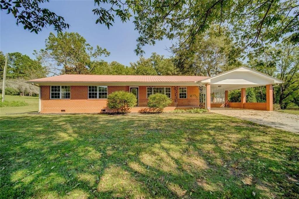 Welcome to peaceful country living! This 3BR/2BA 4-sided brick ranch sits on 2.03 private, level acres in Canton. Inside, you’ll find a spacious layout with a living room, dining room, and kitchen, plus hardwood and laminate flooring throughout for easy care. Relax on the covered front porch, park under the 2-car attached carport, and enjoy the extra touches this property offers — a gazebo for outdoor gatherings, a small barn for storage, and plenty of open land. If you’re looking for privacy, space, and a touch of rural charm while staying close to Canton conveniences, this home is a perfect fit. Flexible rental terms are available: month-to-month or yearly.