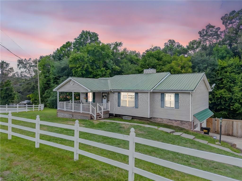 Welcome to this beautifully updated 3-bedroom, 2-bath home perfectly situated on a corner lot in one of Ringgold’s most convenient locations! The home’s curb appeal is undeniable with a classic white vinyl front fence, a spacious front porch complete with a swing, and a fully fenced backyard for added privacy.
Inside, you’ll find a warm and inviting interior featuring all-new vinyl flooring, freshly painted cabinetry, updated lighting, and a cozy fireplace that anchors the living room. The oversized master suite offers a peaceful retreat with a walk-in closet and a recently renovated en-suite bath.
But the value doesn’t stop there—this home also boasts an oversized garage and dedicated workshop space, perfect for hobbyists, extra storage, or future project needs. Plus, the basement provides additional storage space, making this home as functional as it is beautiful.
Step out back to enjoy your private rear deck, ideal for entertaining or simply relaxing while overlooking the peaceful backyard.
Conveniently located just minutes from I-75, Chattanooga, shopping, dining, and more—this home offers a lifestyle of comfort, space, and accessibility.
Move-in ready, full of charm, and packed with functional extras—schedule your private showing today!