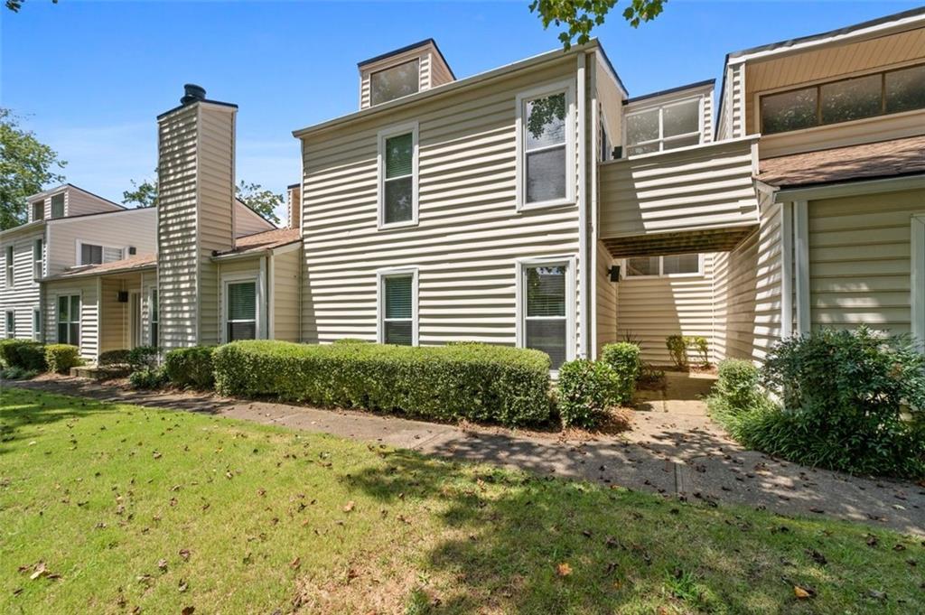 **Modern Comfort in Prime East Cobb Location – Sought-After Walton High School District** Step into this beautifully maintained 3-bedroom, 3 full bath townhome/condo in the heart of East Cobb, offering a stylish contemporary feel and spacious layout. The dramatic 2-story vaulted great room features soaring ceilings, a stunning stone fireplace, and tall windows that flood the space with natural light. The separate dining room is perfect for hosting, while the eat-in kitchen boasts stainless steel appliances and direct access to the covered 2-car carport, making everyday living a breeze. A large bedroom and full bath on the main level offer flexibility for guests, multigenerational living, or a home office. Upstairs, the oversized primary suite is a true retreat with a private balcony, updated en-suite featuring a double sink vanity, and generous closet space. The third bedroom is equally impressive with its own private full bath. Enjoy outdoor living on the large fenced deck—ideal for grilling, entertaining, or simply relaxing. The community offers two saltwater pools, tennis courts, and a clubhouse for added enjoyment. Conveniently located near shopping, dining, entertainment, and the Chattahoochee River, this home combines modern living with an unbeatable location. Zoned for top-rated Walton High School—this one won’t last! **Seller is offering $5,000 in concessions** to be used toward closing costs, interest rate buy-down, or however the buyer chooses—giving you added flexibility and savings.