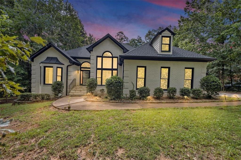 Spacious ranch-style home featuring an open-concept floor plan and a three-sided brick exterior. Offering over 2,200 square feet of living space (per tax records), this home includes a full, unfinished basement that’s already prepped with electrical, plumbing, and 7 out of 8 rooms framed—ready for your custom finishes. The split-bedroom layout provides privacy, with a generously sized primary suite that includes a large bathroom with dual vanities. Enjoy peaceful mornings in the breakfast room overlooking the serene, wooded backyard, or step out onto the deck for a breath of fresh air. Inside, the family room features a cozy fireplace, complemented by a separate living room that can easily serve as an office or flex space. Hardwood floors run throughout the main living areas, while the kitchen, breakfast room, and hallway are finished with elegant marble tile. Additional highlights include a two-car garage and a quiet location in a desirable neighborhood in Southwest Atlanta.