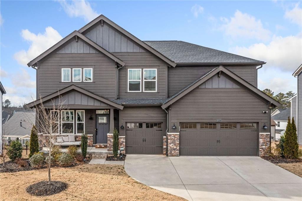 Introducing this stunning 2022 Grandin Pacific Craftsman, where modern style meets timeless charm in one of the most sought-after communities around. From the moment you enter, natural light floods through the upgraded window package, creating a warm, inviting glow in every corner. The kitchen is a showstopper—designed to impress with the largest island package available, sleek quartz countertops, upgraded backsplash, and built-in stainless appliances. Imagine gathering at the breakfast bar, hosting friends around the canopy range hood, or enjoying the seamless flow into the cozy sunroom and covered porch. In the Great Room, soaring ceilings frame a breathtaking two-story stacked stone fireplace, while hardwood floors add elegance throughout the main level, stairs, and upper hall. A private office and stylish mudroom make everyday living effortless. Upstairs, retreat to a spacious Primary Suite with added windows, an accent wall, and a spa-inspired bath featuring a deluxe garden tub, glass tile shower, and double vanities topped with quartz. Three additional bedrooms with en-suite baths ensure everyone has their own space. Downstairs, the finished basement is built for entertaining—complete with a Media Room & projector, wet bar, full bath, and walk-out patio overlooking a fenced backyard. With extra storage and room for a future bedroom, it’s ready to grow with you. Added touches like a central vacuum system make life easy, while the Twin Lakes lifestyle takes it to the next level: 2 private lakes with walking trails, 2 resort-style pools, tennis, clubhouse, fitness center, dog park, cabana, and even a golf cart path straight to Publix!
This isn’t just a home—it’s a destination. Welcome to luxury living at Twin Lakes.