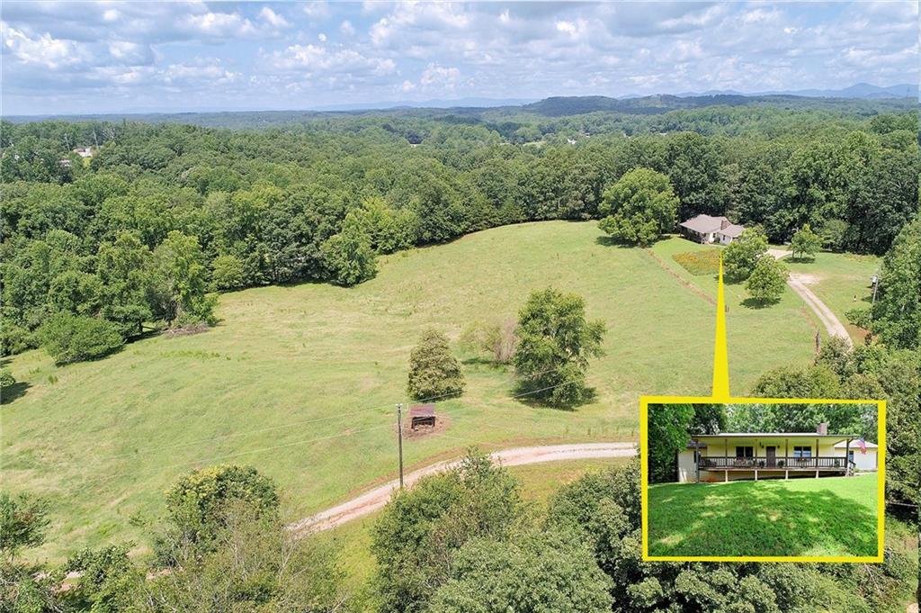 A rocking chair covered front porch welcomes you home to this 20+/- beautiful acres located in the desirable North Hall School district. This home offers a large owners suite with his/hers walk in closets and a large bath with a stepless walk in tiled shower. Located off of the kitchen is a walk in pantry and laundry room. Lots of excellent fenced pasture land with plenty of room for animals and lots of options for additional home sites. This wonderful home place offers the perfect portion of wooded and cleared fenced pastures with two year around flowing creeks. This property checks all boxes for privacy, farming, and/or multi generational living. You will find nice out buildings already on site. The home is tucked away up a long private driveway and sits perfectly above green pastures for a lovely view of sunsets from the large front porch. The covered back deck is the perfect location for your morning coffee and family dinners. This home site offers front and side pastures and a nice wooded area behind the home for ultimate privacy. Come live the country life only minutes from city conveniences. Please note google street view and maps are incorrect.