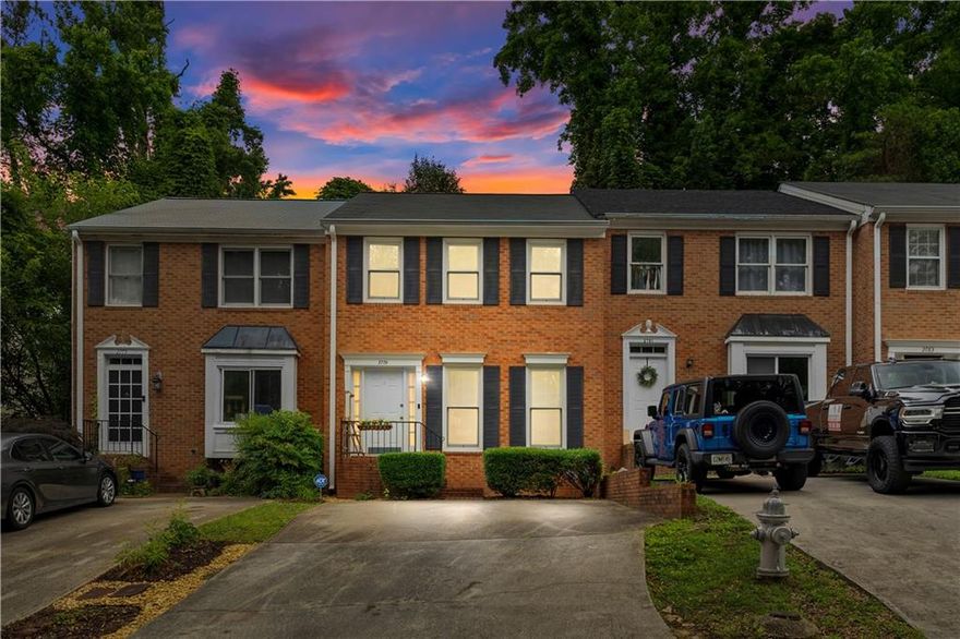 Welcome home to this beautifully updated 2 bed, 2.5 bath fee simple townhome, filled with natural light thanks to upgraded Andersen double pane windows and featuring a spacious, roommate friendly layout with double primaries on the second floor! You're welcomed by stunning hardwood floors and crown molding throughout the main level, which includes a grand entry foyer, dining room, kitchen, living room, half bath, and multiple storage closets; including convenient under stair storage. The heart of the home is the gorgeous kitchen, boasting granite countertops, under cabinet lighting, and soft close cabinets and drawers. Enjoy meals in the sun filled dining room or relax in the large living room with a gas starter fireplace. Step outside to your private, fenced courtyard featuring upgraded weather resistant composite decking and a charming stone wall. Upstairs, two generously sized primary suites each offer ensuite baths with granite, plus walk-in or his-and-hers closets; perfectly separated by a central laundry closet for convenience. With no HOA or rental restrictions, the thoughtful upgrades throughout, and a prime location within walking distance to Truist Park and The Battery, this East Cobb gem truly stands out!
