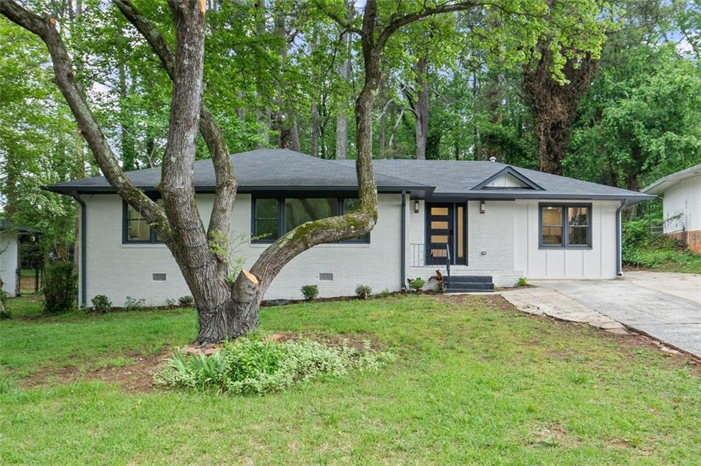This sophisticated and modern home has been completely remodeled and is ready for you to move right in. Featuring 3 bedrooms and 2 1/2 bathrooms, every detail has been thoughtfully upgraded, including new appliances, new plumbing, new LVT flooring, new lighting, stylish fixtures and outlets, new cabinets, new countertops, and fresh door trims. The home also features a smart front door lock, a new electric water heater, and an exhaust fan with a built-in speaker for added comfort. The open-concept kitchen is truly a centerpiece, featuring a detailed tile backsplash, an extended island with seating, a beautiful farmhouse sink, and a stunning combination of wooden and white cabinets that create a perfect balance of warmth and brightness. A wall-mounted pot filler adds convenience and a luxurious touch to the space.
The light fixtures throughout the home add an elegant, sophisticated feel that perfectly complements the cabinetry, countertops, and the overall modern design. The master bedroom is a peaceful retreat, featuring a stylish barn door, a spacious walk-in closet, and direct access to the spa-like master bathroom. In the master bath, you’ll find double sinks, double shower heads, a soaking tub, and wall-mounted brass faucets, making it the perfect place to relax and unwind. Every inch of this home has been carefully crafted to blend contemporary style with ultimate comfort. Hurry—this stunning listing won’t last long!