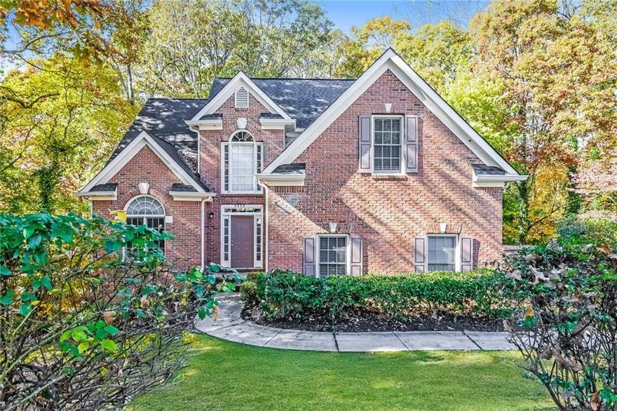 Five Bedroom, Three and One Half Bathroom Brick-Front Traditional Home located in the popular Hamilton Mill Community in Mill Creek High School District.  Entering the home you will find Dining Room to the Left and Family Room and Kitchen straight ahead.  Kitchen features white wooden cabinets, stone countertops and stainless steel appliances.  Kitchen has view of Family Room with fireplace.  Primary Suite is located on the Main Level with Primary Bath that includes double vanity, soaking tub and separate shower.  Powder Room located off Entry Foyer.  Laundry Room is located on the Main Floor just off the hallway near the Primary Suite.  Two Car Garage.  Three Secondary Bedrooms and One Secondary Bathrooms on the Upper Level.  Basement features a Bedroom and Bathroom, Flex / Game / Play Area with Unfinished Space great for storage.  Private fenced wooded Backyard.  Walk to Community Clubhouse with Fitness Room, Soccer and Baseball Fields, Swim and Tennis, Sand Volleyball and Community Lake. Close to Shopping, Restaurants, Library and Parks as well as the Mall of Georgia.