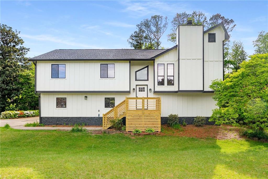 Welcome to 3152 Normandy Circle—a fully renovated 4-bedroom, 3-bathroom home on a spacious, corner lot in the heart of East Cobb. This thoughtfully redesigned residence boasts approximately 2,000 square feet of modern living space, blending elevated design with flexible functionality for today’s lifestyle. The upper level features an open-concept living room anchored by a sleek electric fireplace framed in custom wood slats, oversized windows that flood the space with natural light, and wide-plank flooring that flows throughout. The brand-new kitchen is a showstopper, outfitted with crisp white cabinetry, quartz counters, a hexagonal tile backsplash, matte black fixtures, and a generous walk-in pantry. A stylish dining room and spacious bedrooms complete the main floor, including a serene primary suite with a newly renovated ensuite bathroom featuring a tiled walk-in shower and modern single-sink vanity. Downstairs, you'll find incredible flexibility with a second full kitchen, a fourth bedroom, and a third full bath—perfect for multigenerational living, guests, or a private work-from-home suite. Outside, the home sits on a lush, level lot with a huge backyard—a true rarity in this area—ideal for pets, play, or entertaining. The brand-new rear staircase leads to a covered lower patio and flagstone path, while a separate concrete patio offers another private outdoor retreat. Additional highlights include a spacious two-car garage, updated systems, and contemporary lighting throughout. Located near excellent Cobb County schools and just minutes from parks, playgrounds, restaurants, shopping, and the vibrant scene at Marietta Square, this home offers the perfect balance of peace, practicality, and modern comfort. Whether you're looking to settle in, expand, or create a multi-functional lifestyle under one roof, 3152 Normandy Circle delivers it all—beautifully.