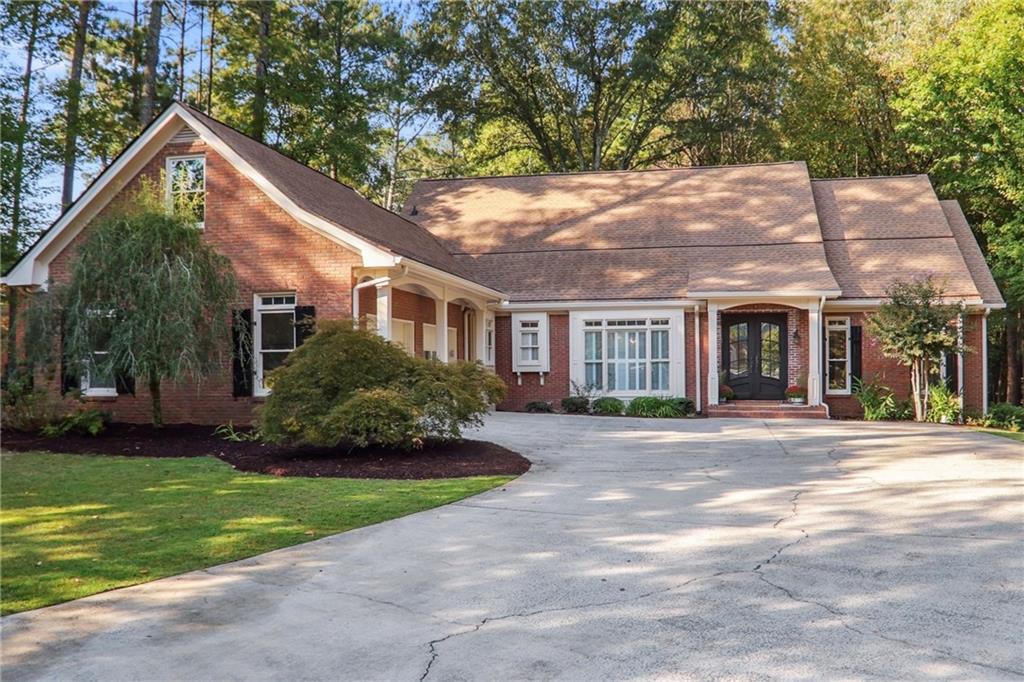 Welcome to this beautiful, completely renovated home in River Club. Conveniently located in Johns Creek, GA next to The Atlanta Athletic
Club. Every surface of this home has been updated. You will find an oversized dining room leading into an equally oversized living room
with a fireplace, coffered ceilings, and a beverage station. Adorned with an exposed brick wall that separates the living room and kitchen,
the kitchen is completely new with all new THOR appliances, flooring, soft close cabinets, and fixtures. The kitchen also boasts a walk-in
pantry with built-in shelves. The primary suite is large with plantation shutters and the primary bathroom is complete with double vanity, a
new soaking tub, a new tiled shower and a large walk-in closet. As you ascend the stairs to the second story you will find new iron and
wood railings that lead to 4 large bedrooms. Above the garage was finished into a flex space with a bedroom and new bathroom. Great for
a media room or a secondary suite. The covered patio has new brick flooring and a brand new large outdoor living space overlooking a
wooded backyard. The home has a new roof and a new HVAC unit, new floors, new paint, new deck, new kitchen and all bathrooms. Foam
insulation was installed and the crawl space has been sealed and insulated. Let's just call this home move-in ready! Please note several
pictures have virtual staging added.