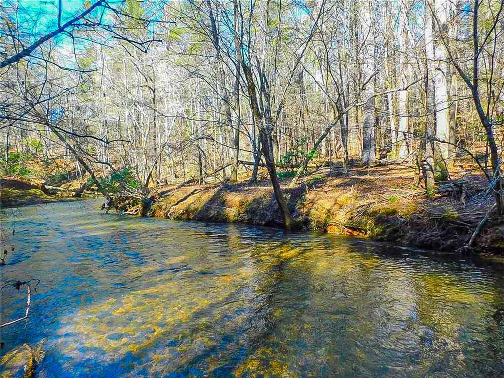 It's back! In case you missed it when it last hit the market, here is your chance to own gorgeous, workable property on the storied Yahoola Creek! Rare opportunity to own a special piece of creek front property, with paved county road frontage on one of the most picturesque roads you'll ever find. Enjoy privacy and space bordered by seemingly endless US National Forest as well as other estate sized tracts, the property features multiple build sites and over 300 feet of creek frontage on each side; this 15.42 acre property includes both sides of a wide noisy creek, protecting your views and water access. Located near the end of a county maintained paved road, this quiet sanctuary feels like you're out in the wilds, yet is only five miles from vibrant downtown Dahlonega and just minutes to award winning wineries, restaurants and boundless outdoor adventure. Yahoola Creek has consistent flow and great volume in every season, in fact old maps of the county often refer to it as the Yahoola River! Recently surveyed, this majestic forest setting enjoys no HOA, allowing you to create your dream home and lifestyle in one of the most beautiful locations in all of North Georgia. This property was but a blip on the market for 11 days before getting snatched up a little over a year ago and before that had not seen the market for almost 50 years! This is it!