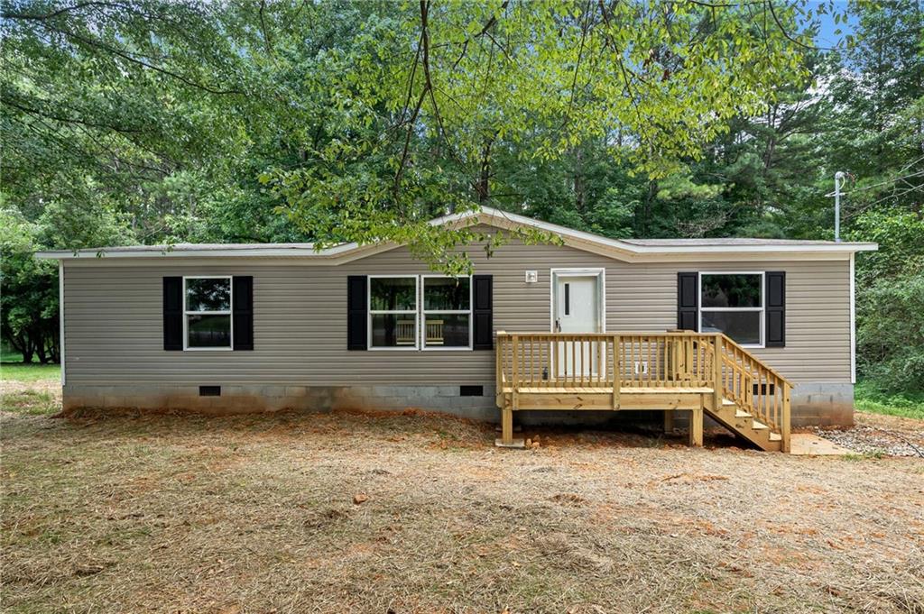This completely move-in-ready 3-bedroom, 2-bath home sits on nearly an acre and offers 1,264 square feet of open, comfortable living. Everything is brand new—including the roof, HVAC, appliances, flooring, and more—giving you peace of mind and modern convenience from day one. The split-bedroom layout provides added privacy, while the spacious kitchen with a large island and the primary suite with a walk-in closet make everyday living feel effortless. Clean lines, fresh finishes, and a quiet setting complete this beautiful home.