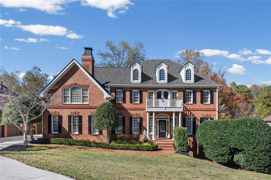 Nestled in the heart of East Cobb's top Walton High School district, this welcoming residence presents an amazing design crafted with quality details and is offered in wonderful condition. Current owners have invested over $140K in improvements to the property.  This inviting home welcomes all as you step into the open two story foyer and behold a lovely curved stairway that leads to the upper level.  The home stands as a testament to sophisticated design with tray and coffered ceilings, as well as crown molding that accentuate the space with superior craftsmanship, creating an atmosphere of refined elegance, while built-in shelves and hidden pocket doors offer both functionality and aesthetic appeal. The dual-sided fireplaces are a focal point, promising warmth and ambiance, complemented by the soaring high vaulted ceilings that enhance the room's spacious feel. In the kitchen, culinary dreams come to life amidst a spacious kitchen with granite counters, providing ample space for both preparation and gathering. The kitchen peninsula bar offers additional seating and serving options; in addition, the backsplash and crown molding add a touch of sophistication. The property boasts five bedrooms, four full bathrooms, as well as 2 powder rooms, offering plenty of private space.  The oversized primary suite is truly exceptional with a dual-sided fireplace that connects the primary bedroom to a cozy sitting area amidst built-ins and a private wet bar; then enter the primary bath/spa area to a large walk-in closet with custom shelving + a second walk-in closet for storage; the light filled primary bathroom/spa offers his & her vanities, a soaking tub, separate tiled shower, linen closet and private water closet. 
The upper level offers a split bedroom design on the opposite wing of the house, where 3 additional secondary bedrooms are, including a guest bedroom with built-ins and a private ensuite bathroom; the 3rd and 4th bedrooms share a spacious Jack & Jill style bathroom with dual vanities.
The expansive terrace level features a large recreational area, a 5th bedroom / bonus room, a full bathroom and lots of space for storage.   French doors lead out to the large multi-tiered deck that extend the living space outdoors, providing areas for relaxation and enjoyment of the private wooded backyard. This beautiful brick home offers an unparalleled living experience, blending amazing design with quality accents to create a truly exceptional home.
The Waterford Green subdivision is conveniently located near the Gold Branch Trail, Willeo Park, Azalea Park, Chattahoochee Nature Center as well as shopping (the Avenues of East Cobb) and restaurants (near Historic Roswell area).
