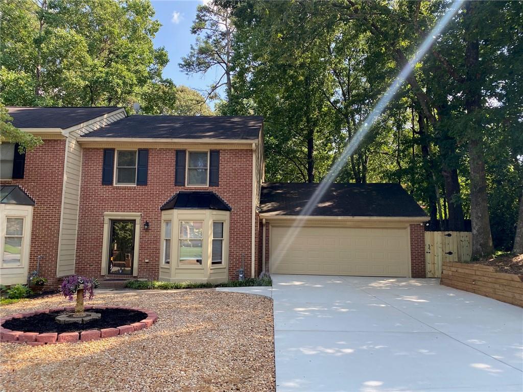 This 2 bedroom 2.5 Bathroom wooded, corner lot townhome is ready for a new tenant! Both 2nd story bedrooms are "suites" as each has an attached full bath. The laundry is conveniently located upstairs, and the main suite has a whirlpool tub. This home is newly renovated with all new carpet upstairs and Luxury Vinyl Planks downstairs; all new interior paint, and a new granite countertop in the eat-in kitchen. There is a large under-stair storage area on the main floor. A gas fireplace is the highlight of the open concept living room and pass through kitchen area. The detached 2 car garage boasts a workbench and cabinets, and opens out to a newly poured patio and fully fenced backyard. This home is within walking distance to Marietta Highschool, grocery shopping and restaurants. It is located off of Dallas Highway, within a 5 minute drive to Historic Marietta Square and Marietta Market with endless local theater, seasonal outdoor entertainment, bars, restaurants, and specialty shops. Fabulous location, unique lot, and newly renovated - a must see! Availability September 26th.