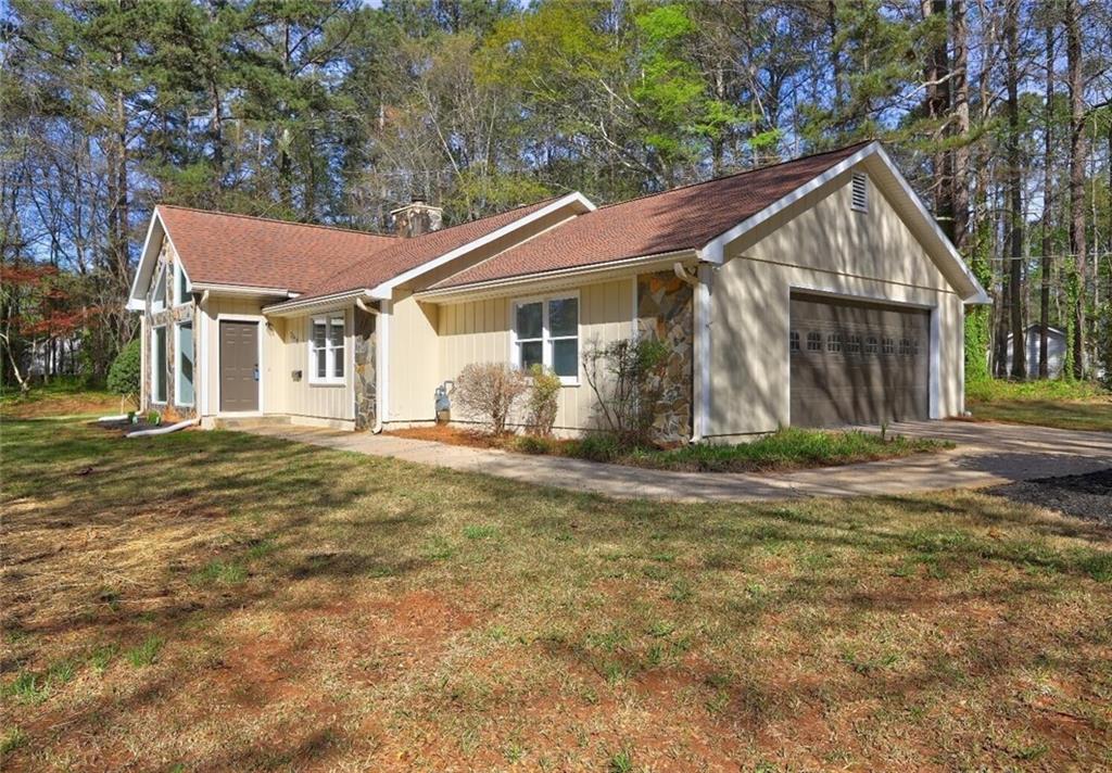 Welcome Home! This beautifully maintained turnkey 3-bedroom, 2-bathroom ranch-style home sits on a generous 1.18-acre corner lot in the highly sought-after Fairburn community. Step inside to discover a home full of character—vaulted ceilings, large windows, and an eye-catching fireplace that serves as the centerpiece of the great room, creating a warm and inviting space perfect for relaxing or entertaining. Natural light cascades throughout the home, enhancing the spacious, open feel of each room. Enjoy the convenience of being just minutes from Publix, Starbucks, Chick-fil-A, and other popular stores and restaurants. Whether you're a first-time homebuyer or a family looking for comfortable, single-level living on a large lot, this home has it all. Don't miss your chance to make this stunning Fairburn property your new home!