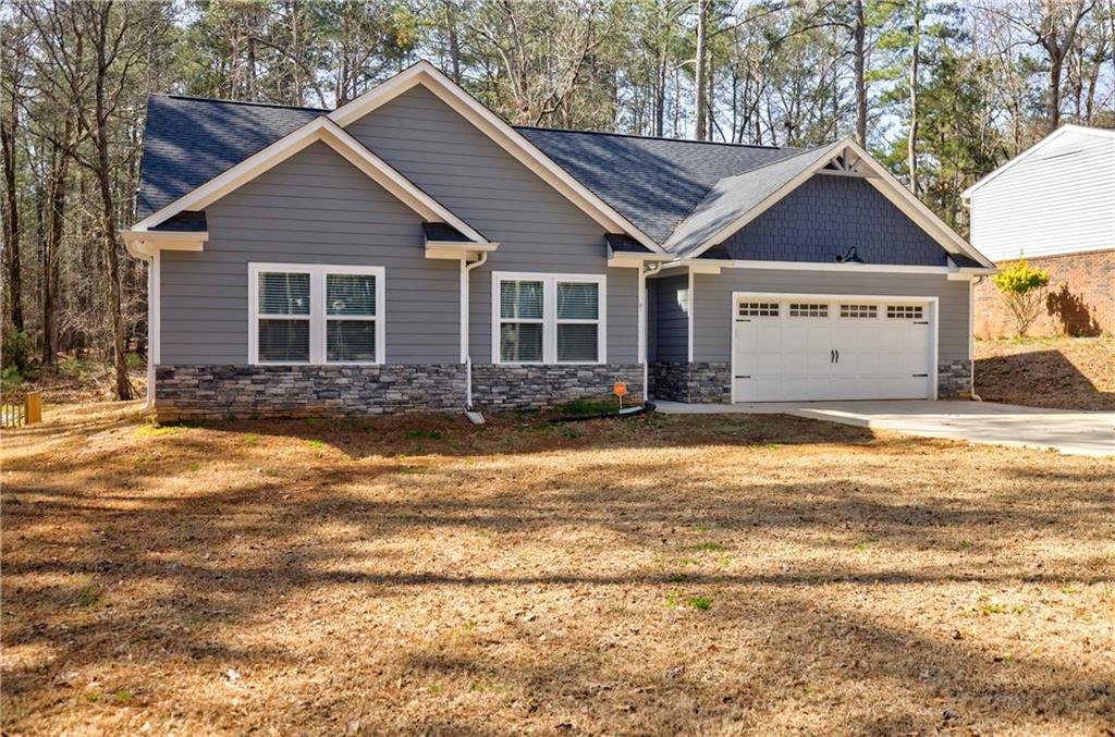 Welcome to this nearly new 3-bedroom, 2-bathroom home located in the gated community of Fairfield Plantation. This thoughtfully designed residence offers an open-concept layout with premium upgrades throughout, including custom cabinetry, granite countertops, and upgraded appliances in the gourmet kitchen. The living area features beautiful beamed ceilings and hardwood-style floors that create a warm, inviting atmosphere. The spacious primary suite includes a walk-in closet and a well-appointed en-suite bathroom for your comfort. Situated on a 0.31-acre lot, the outdoor space provides plenty of room for relaxation, entertaining, or gardening. Enjoy all that Fairfield Plantation has to offer—resort-style amenities including swimming pools, tennis courts, parks, a golf course, and recreational facilities. Move-in ready and available just in time to enjoy the rest of the summer—no waiting on new construction! Don’t miss the opportunity to own this stunning home.