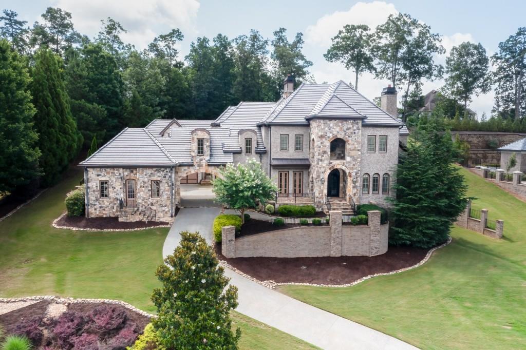 This Estate Home is located in the prestigious gated community of Grand Estates of the South. This private coveted neighborhood has only 22 lots. The gorgeous brick and stone masterpiece has 3 finished levels with a 3 stop elevator,master on the main level with fabulous master bath and oversized closet, beautiful iron entry doors, large kitchen with designer wolf and sub-zero appliances, granite counters, coffered ceilings, beautiful custom lighting throughout, hardwood floors, new plush carpet,media room, workout room, large covered patio, second kitchen in au pair suite, private backyard with room for a pool. You will feel a sense of luxury and grandeur as you enter through the porte cochere into the motor court with 4 car garages. The expansive terrace level features a media room, workout room, two bedrooms, large bathroom, gathering area and a large partially finished space for a fabulous wine cellar or library. This estate offers beautiful views from every room as you are sitting above the neighborhood from this commanding site. Warm and inviting color pallet and 5 fireplaces provide for the perfect ambience.You will love how the kitchen transitions seamlessly into the keeping room for an open yet warm feeling. This estate has professional landscaping and private gardens if you desire to grow your own spices and vegetables. Truly a remarkable place to call home.