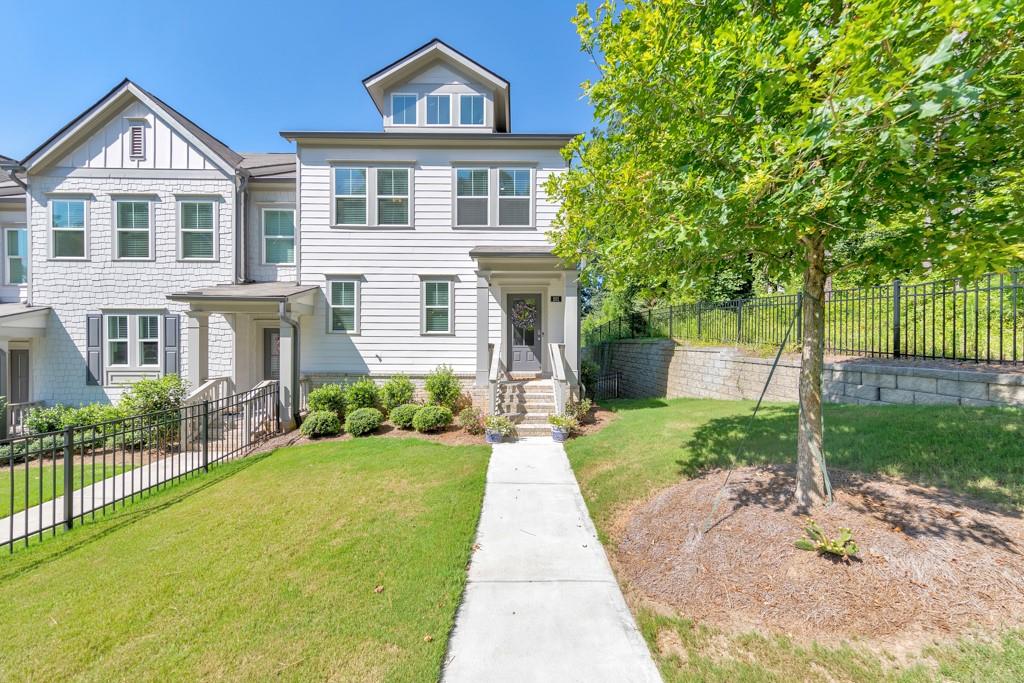 Don’t miss this gorgeous end-unit townhome in the heart of Woodstock! Investor-friendly with no rental restrictions! Built in 2022, this 3 bedroom, 3.5 bathroom home offers upgraded finishes including crown molding, recessed lighting, and the privacy that comes with being an end unit. This is the only end-unit currently for sale in the community and features one of the largest yards—perfect for outdoor enjoyment and entertaining. The open-concept main floor showcases a modern kitchen with white cabinets, stone countertops, stainless steel appliances, a pantry, and an island perfect for casual dining. The fireside family room opens to a rear deck, creating the ideal spot for entertaining or relaxing. Upstairs, the primary suite features a walk-in closet and luxurious ensuite with double vanities and a glass-enclosed shower. Two additional bedrooms, a full bath, and upper-level laundry complete the space. Downstairs, the terrace level includes a full bathroom and a versatile bonus room—ideal as a fourth bedroom, office, or media space. Additional highlights include a whole-home dehumidifier for the HVAC system, a fenced front yard, and a 2-car garage. All just minutes from Downtown Woodstock and Noonday Creek Trail.